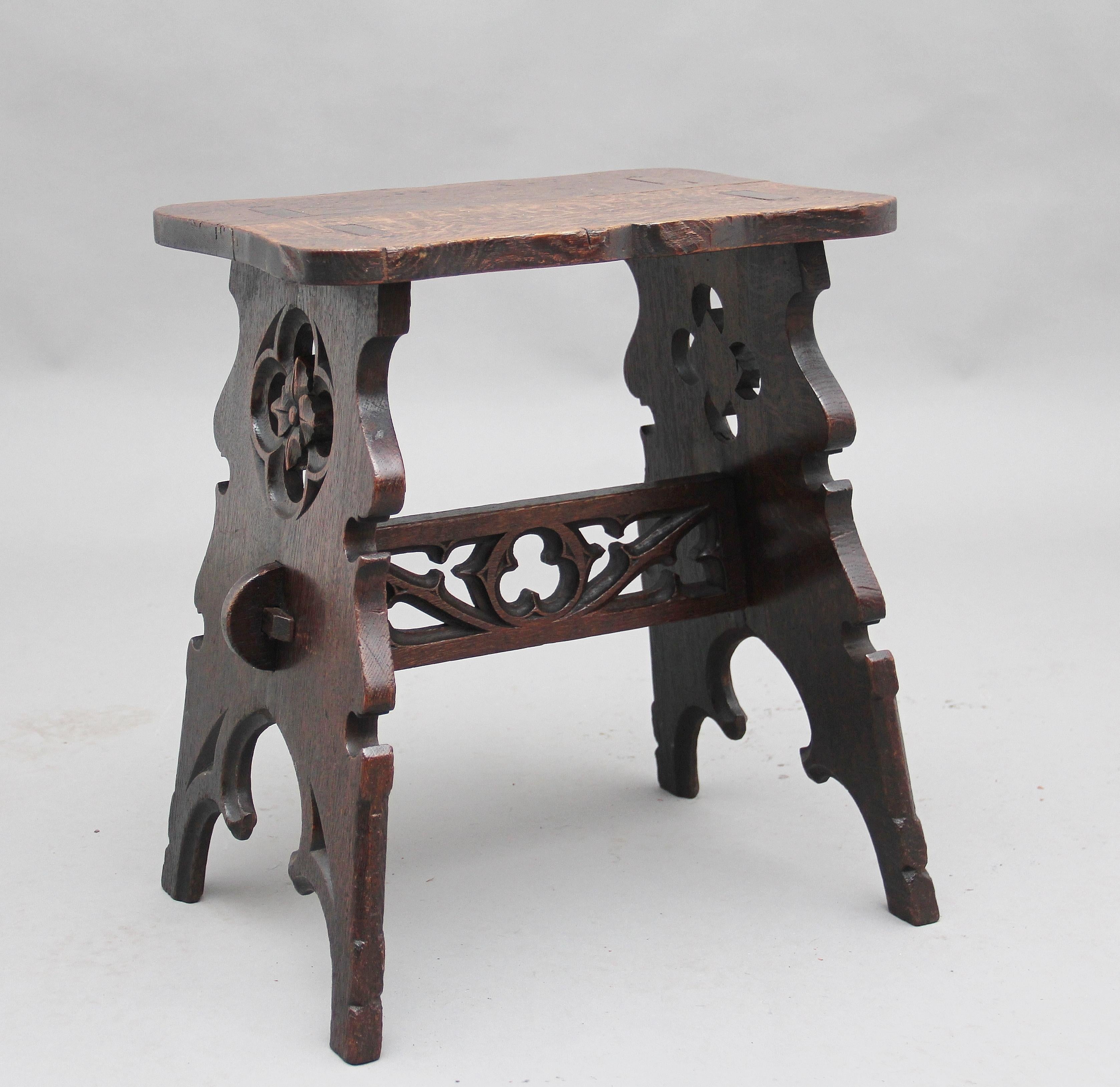 19th century Gothic revival oak stool, the shaped rectangular top above Gothic supports and stretcher, circa 1860.