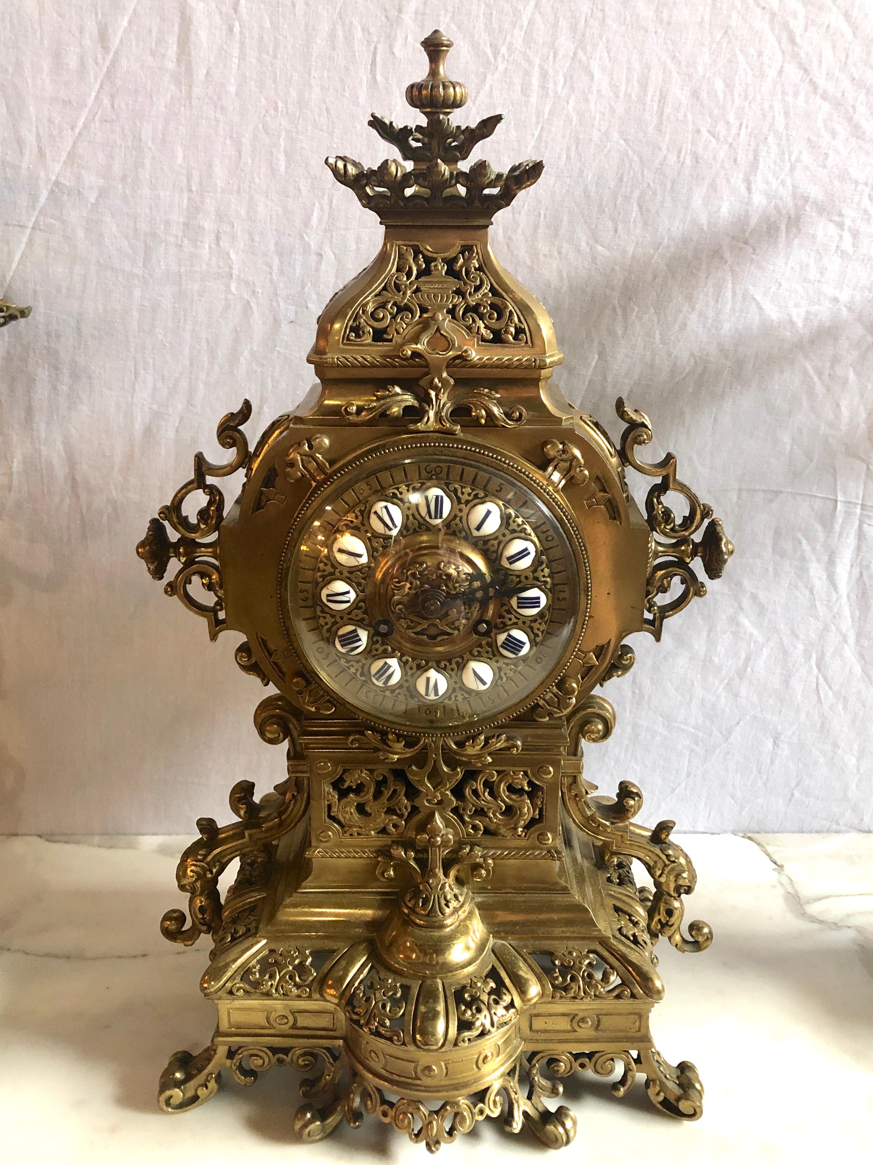 A simply stunning Gothic Style J.E. Caldwell (1882) gilt bronze clock garniture set. A finely cast bronze clock with a pair of matching candelabra each 24 inches tall having five arms and the pair retaining their original snuffers.
James Emmett