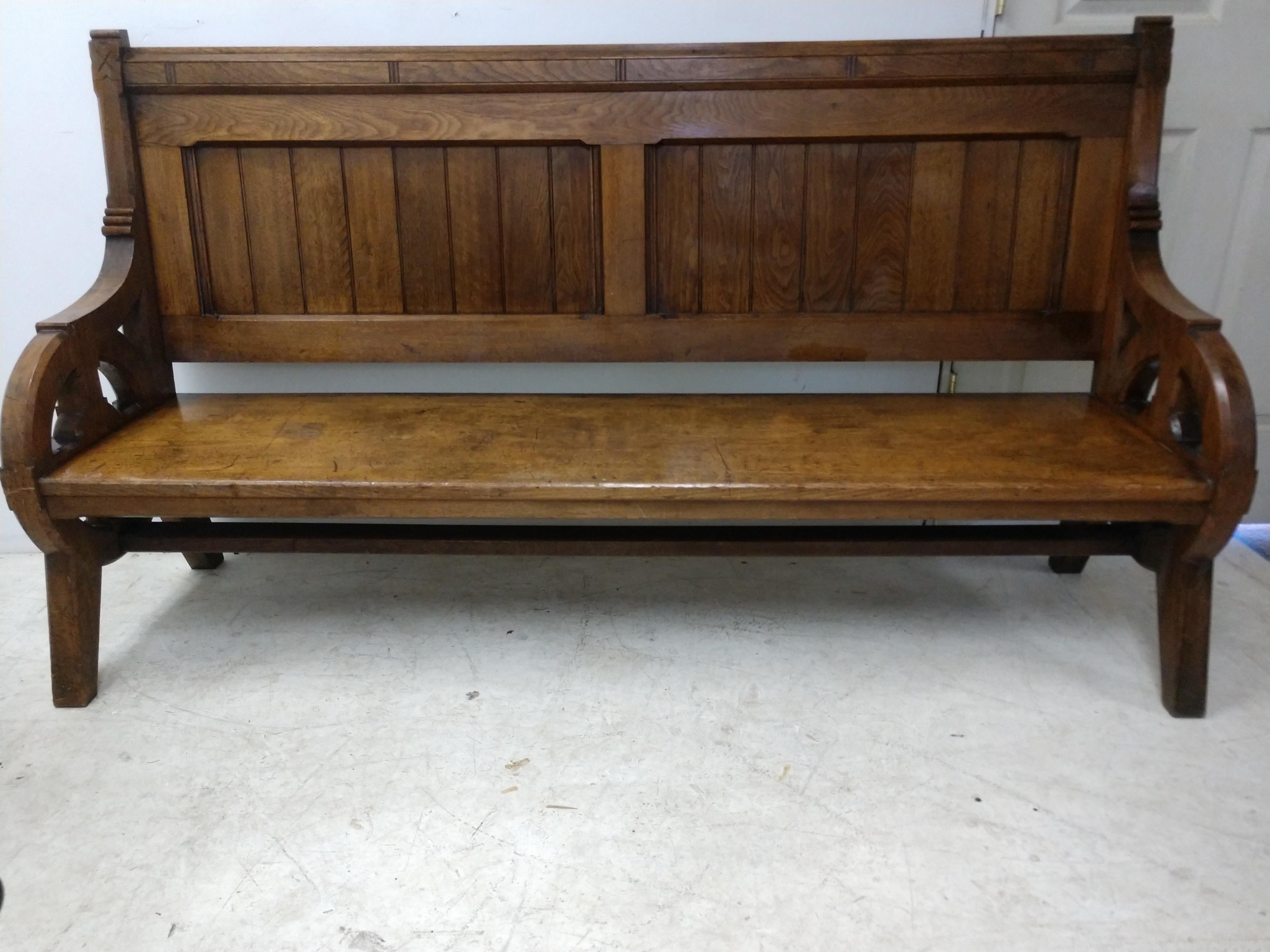 Beautiful design, pierced arm with supports, paneled on both sides and heavy duty 2 inch thick walnut. Seat is one board and 17.5 inches wide. Seat hgt. is 16 inches. In excellent vintage condition with minimal wear. Piece was totally reglued.