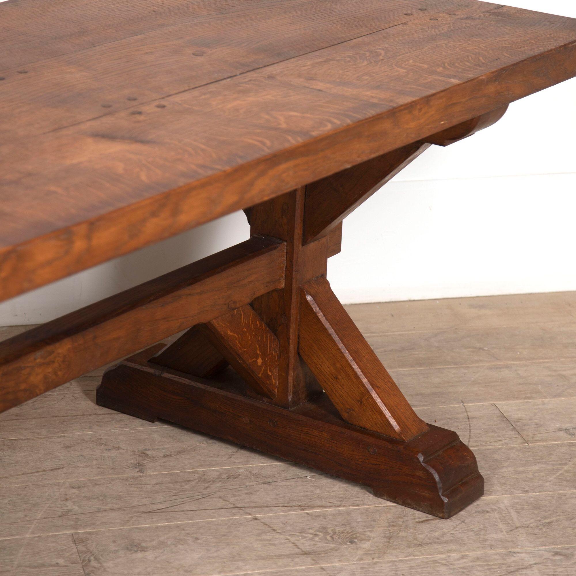 Superb 19th century oak dining table of great quality.
This table features a very bold, gothic design with an X frame.
Features a three plank top with a gorgeous golden colour. There is a minor warp the top but once in the pegs it sits solid. The