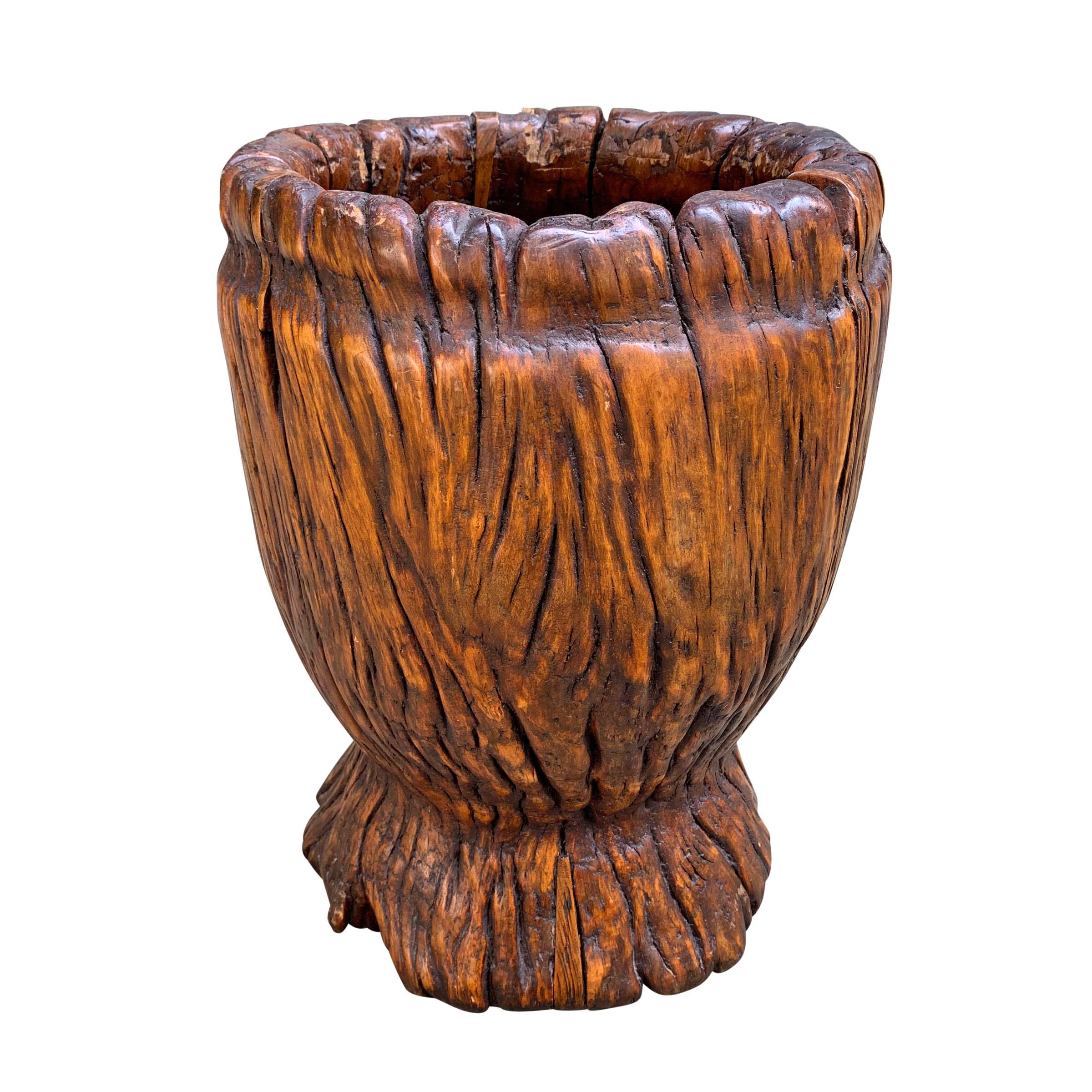 A fantastic sculptural 19th century grain mortar of one piece of wood with a wonderful patina that glows! Would be an incredible waste paper basket in a powder room or office. Could be also be planted with a tree if it were lined.