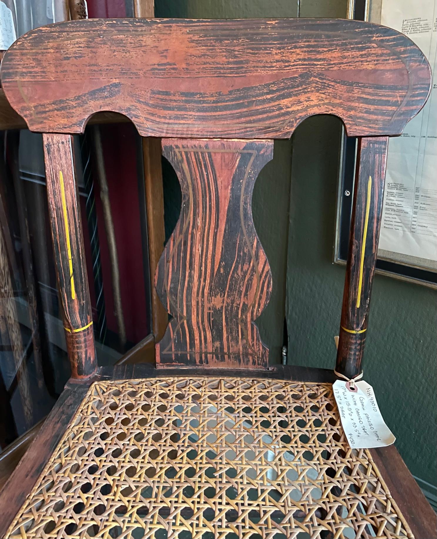 19th century side chair with bold grain paint throughout, turned stretcher, and all with intermittent gold painted highlights, cane seat.