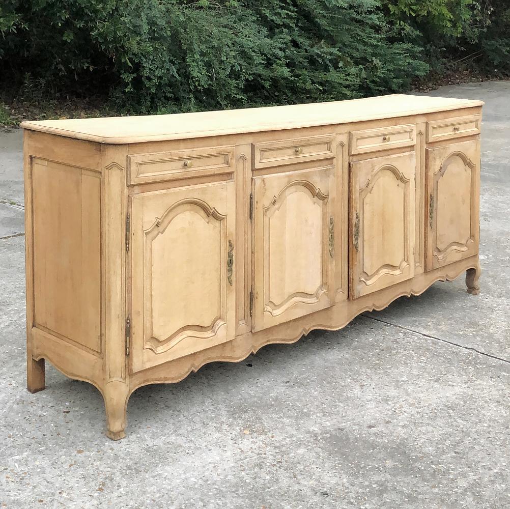 19th century Grand Country French stripped oak buffet is a stately piece, with room inside to store most families' entire collections of china, crystal and flatware! Tailored lines include an undulating apron with scrolled legs appearing under the