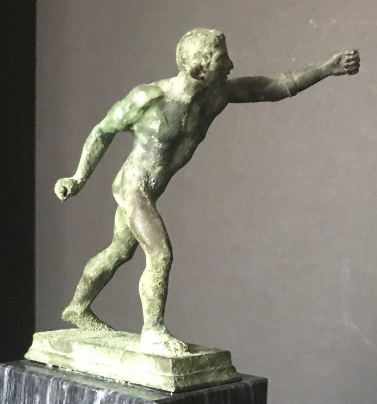 A neoclassical Italian bronze nude figure, with verdigris patina, of the Borghese Gladiator on a raised marble base.

