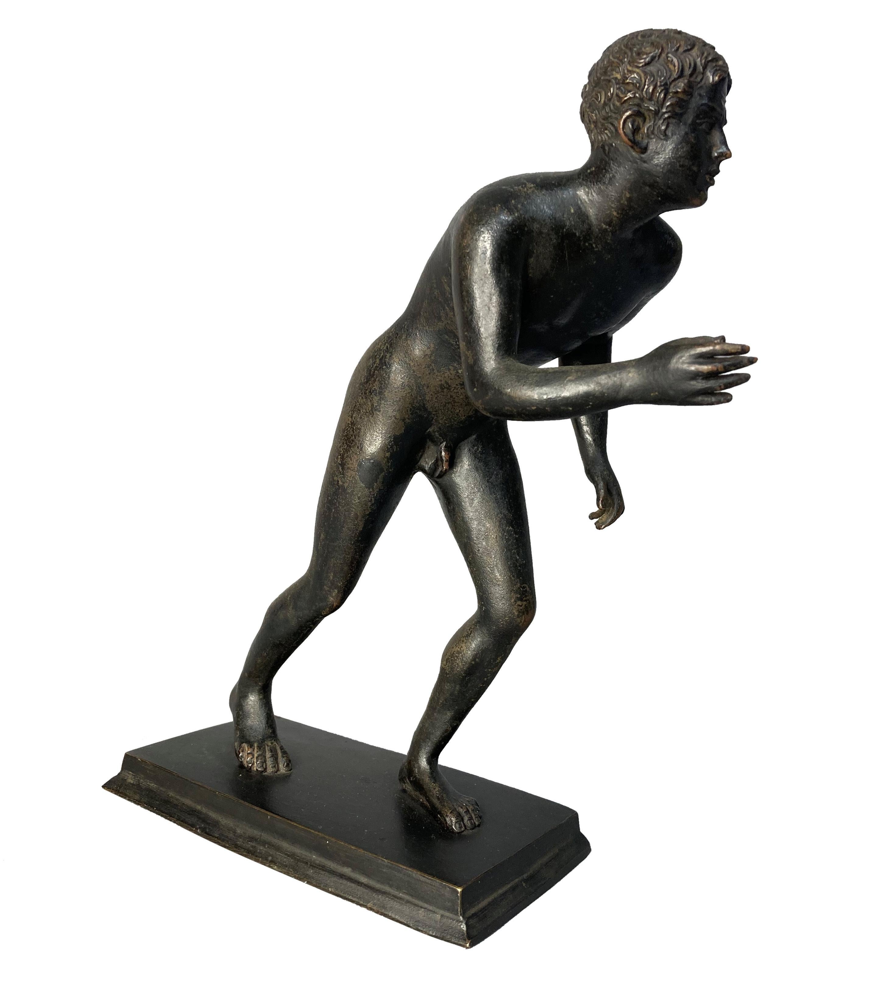 An English Grand Tour bronze figure of a running youth with fine detailing and good patina.