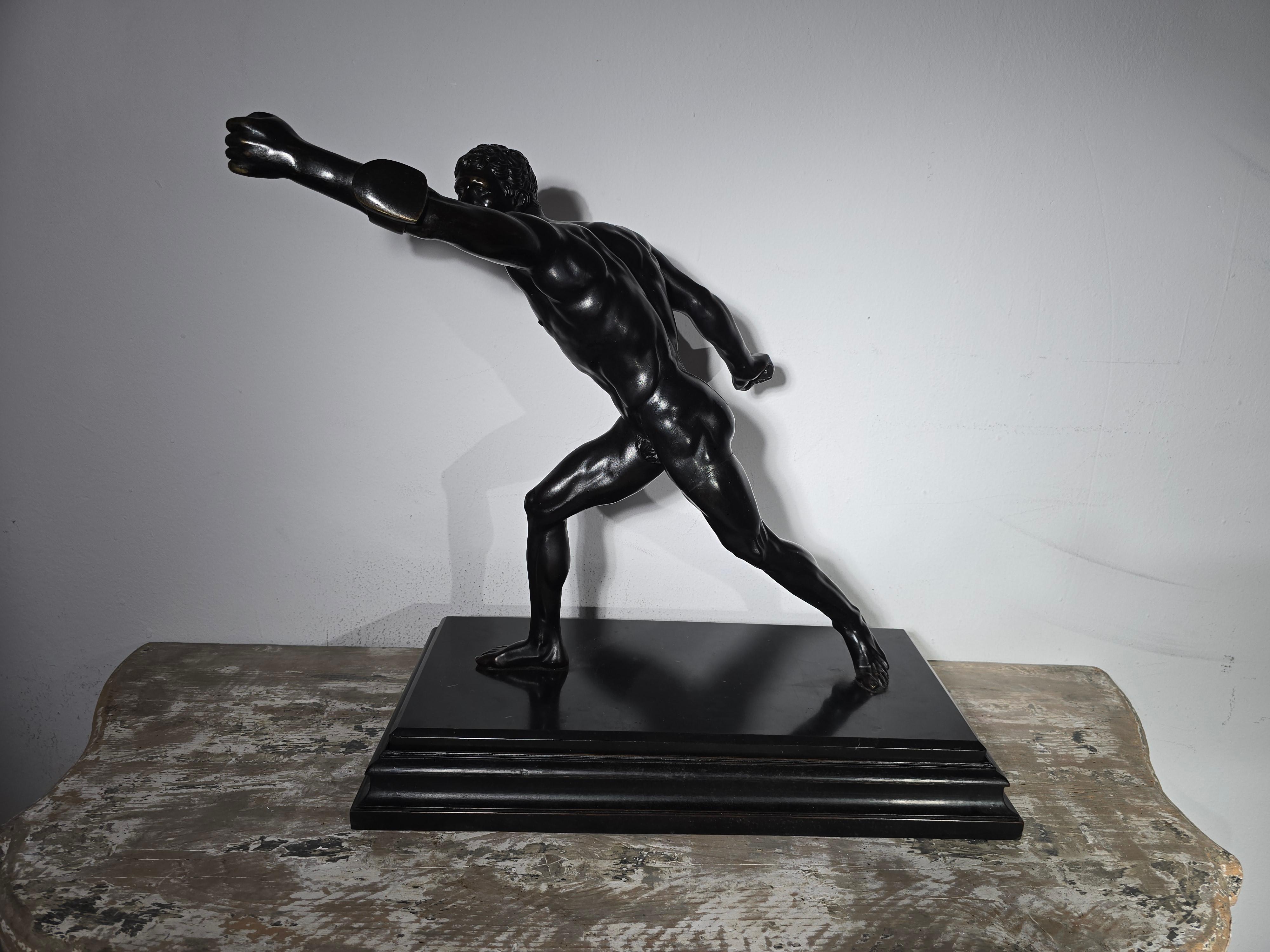 Elegante scultura in bronzo del XIX secolo, tipica del Grand Tour, raffigurante un gladiatore romano in una posa dinamica e possente. La figura, finemente colorata in bronzo, è appoggiata su una base in marmo, anch'essa appoggiata su una base in