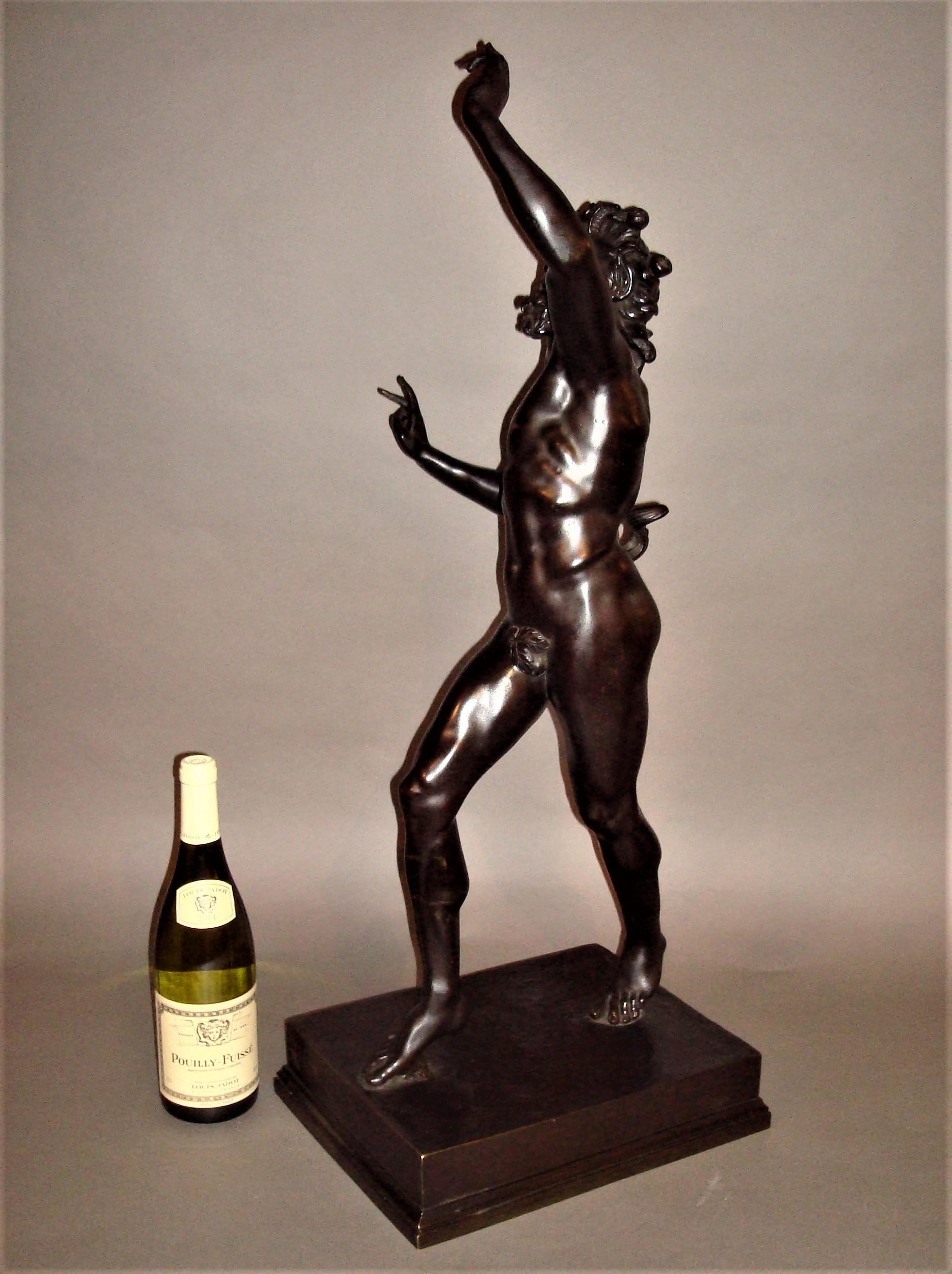 19th century large grand tour bronze sculpture of The Dancing Faun; this classical figure of substantial scale and of good quality with a dark patination standing on a stepped rectangular plinth.

The original excavated in Pompeii in 1830, now on