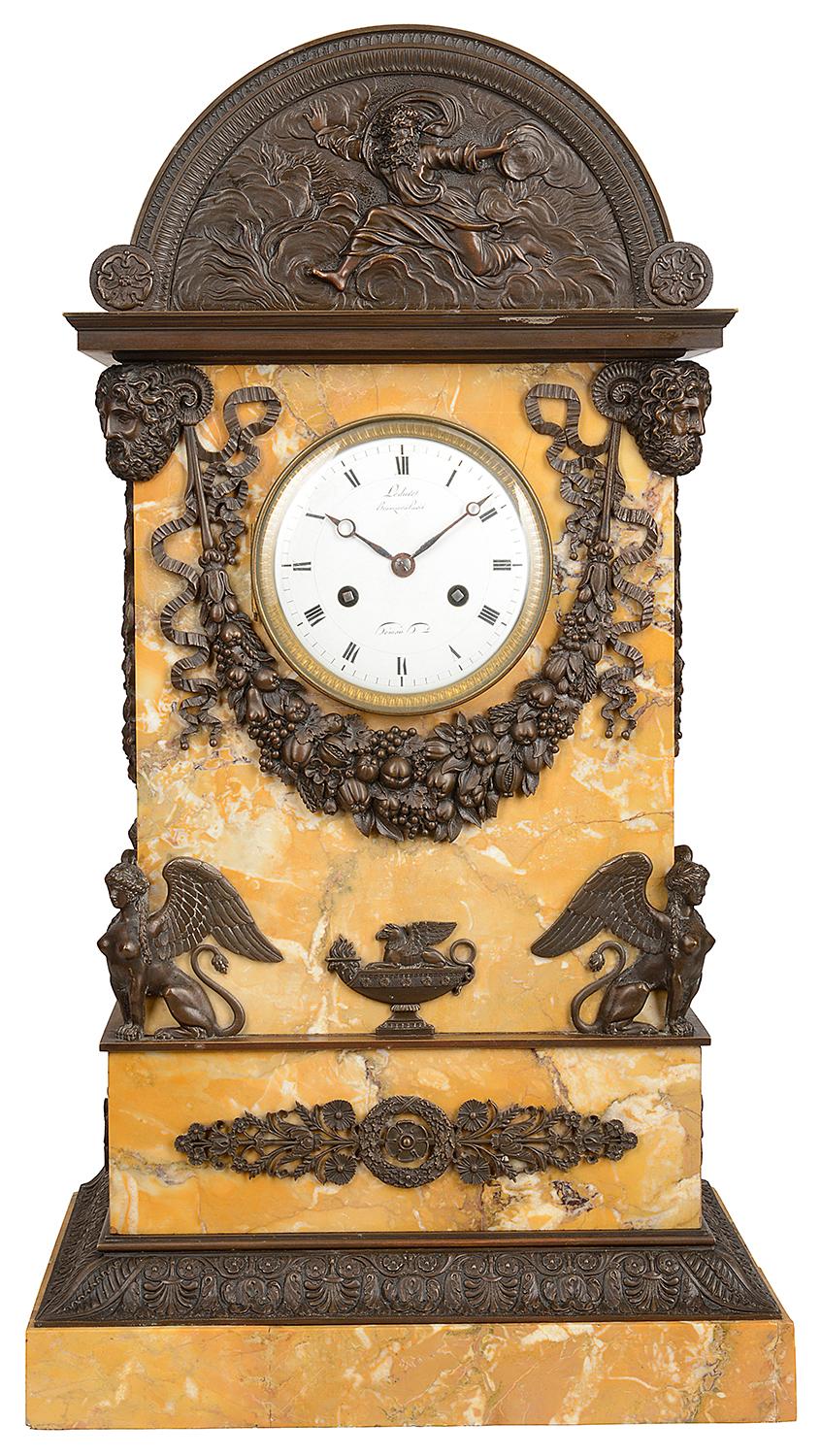 A very impressive 19th century French Sienna marble and bronze mounted Grand Tour influenced mantel clock, having an arched top, mythical gods mounted in bronze with ribbons and swags of fruit. The white enamel dial clock face with roman numerals.