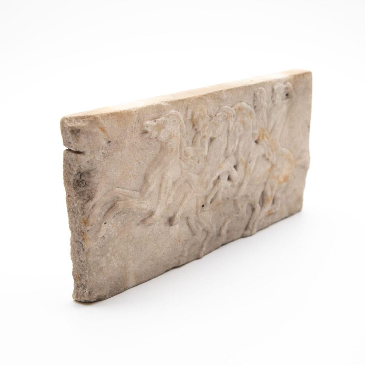 A finely carved Grand Tour marble relief, inspired by the iconic Parthenon Frieze.
Crafted in white marble, this 19th-century piece captures a dynamic procession of horsemen, reflecting the classical artistry of ancient Greece.
Originating from