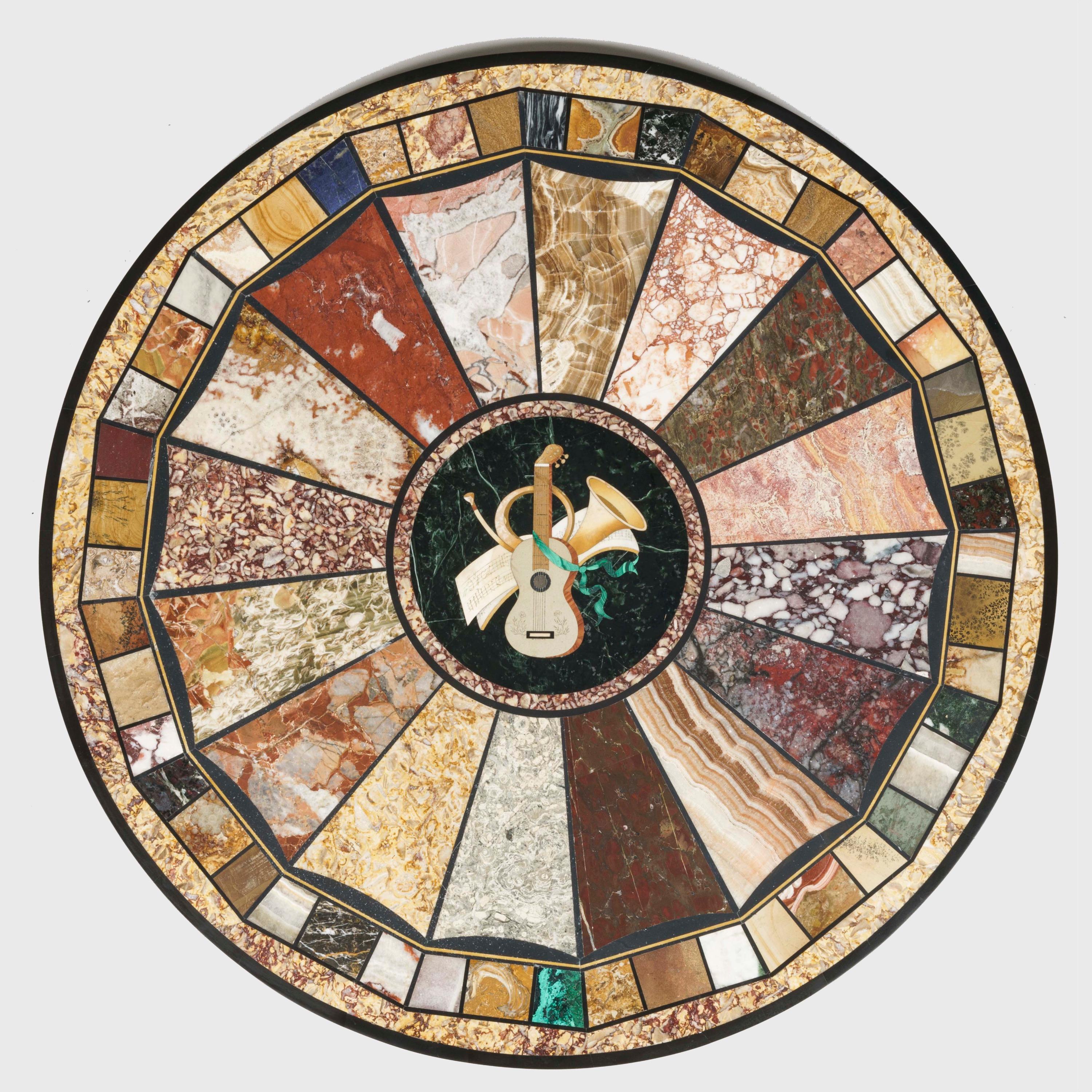 A 'Grand Tour' specimen marble top table

The circular top presenting a geometric mosaic design with a central musical cartouche executed in pietre dure, surrounded by 16 lobed radial wedges and an inlaid border of 48 unique marbles, for a total