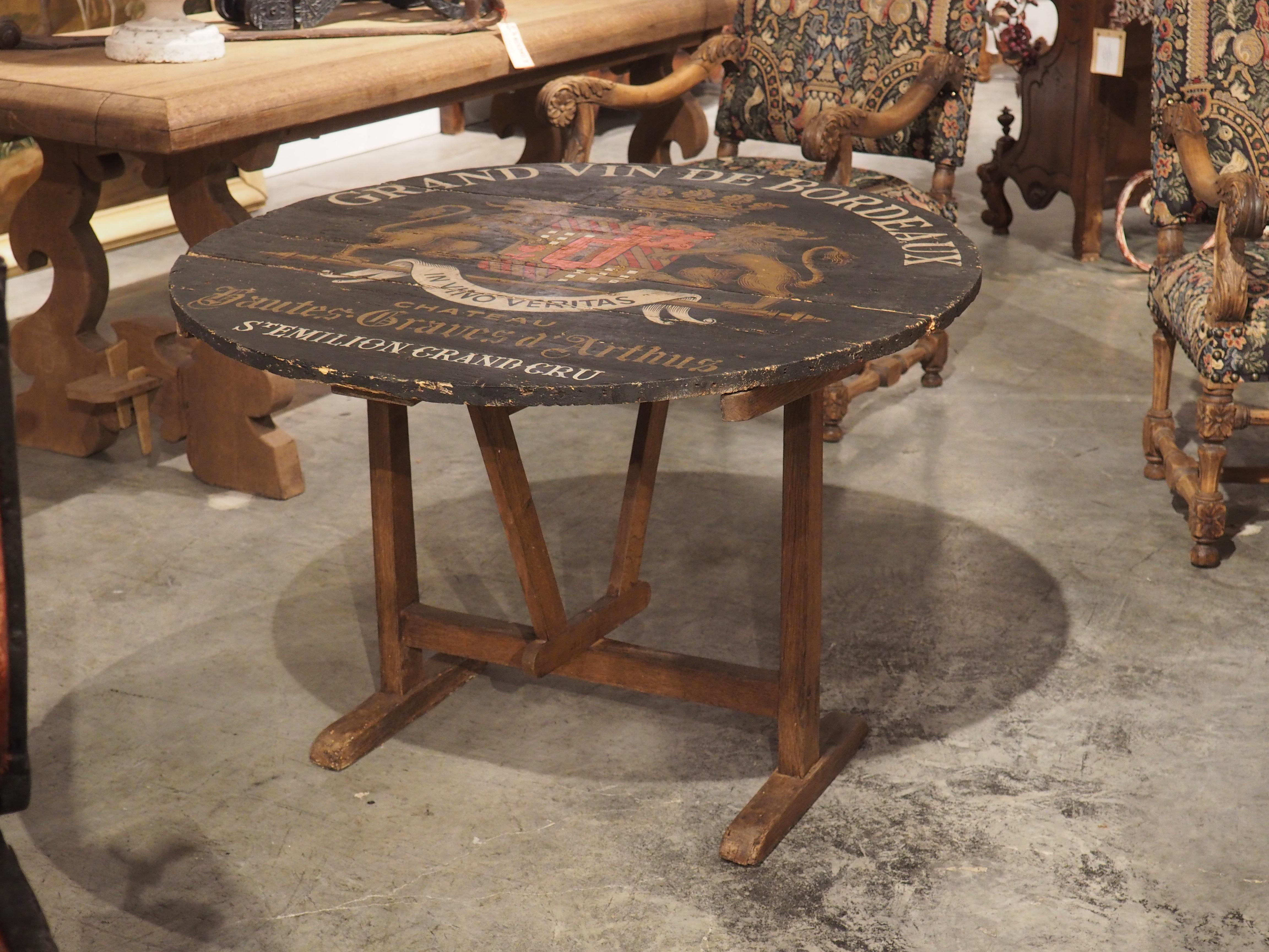 Hand-carved in the late 1800’s, this wine tasting table was produced in typical French fashion: as a circular table with a flip-top that folds down. A geometric support swivels into a locking position, allowing the table to be displayed as a