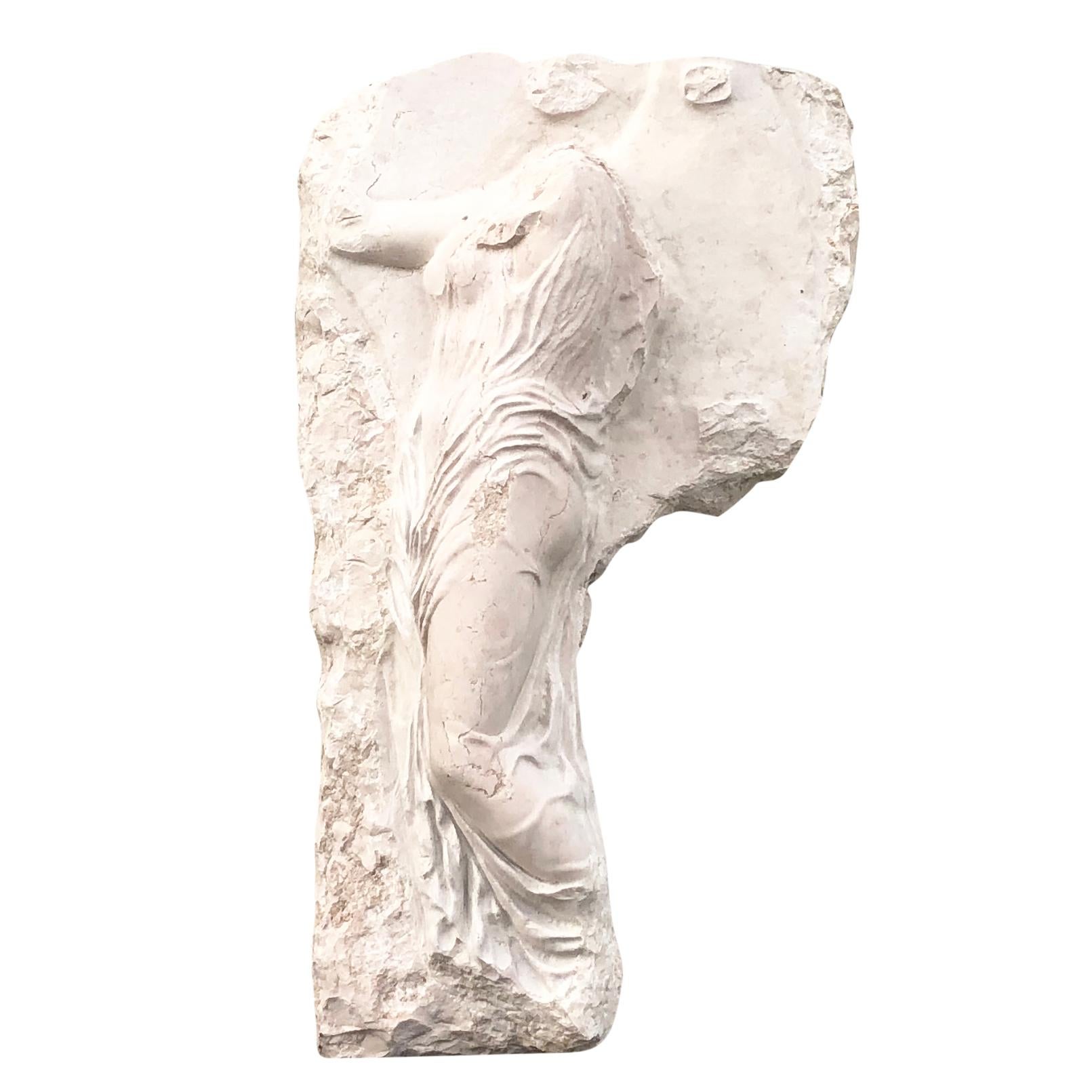 An antique partial wall frieze in marble of Nike, who was the goddess of victory in Greek mythology, in good condition. She was depicted having wings and was the daughter of Titan and Styx. Minor fading, scratches due to age. Wear consistent with