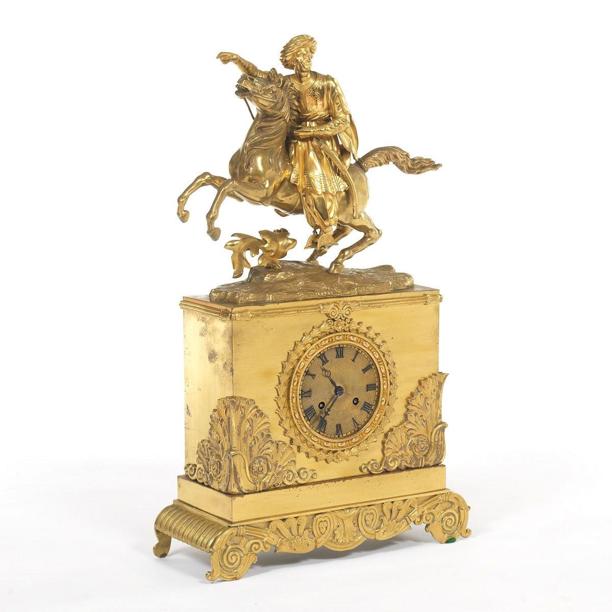 Antique (19th century) gilt bronze and metal mantel clock retailed by Tiffany & Co. depicting a Greek  warrior on horseback.  22 3/4 by 12 1/2 by 5 inches.  Rear marked TIFFANY & CO.  With original pendulum and key.