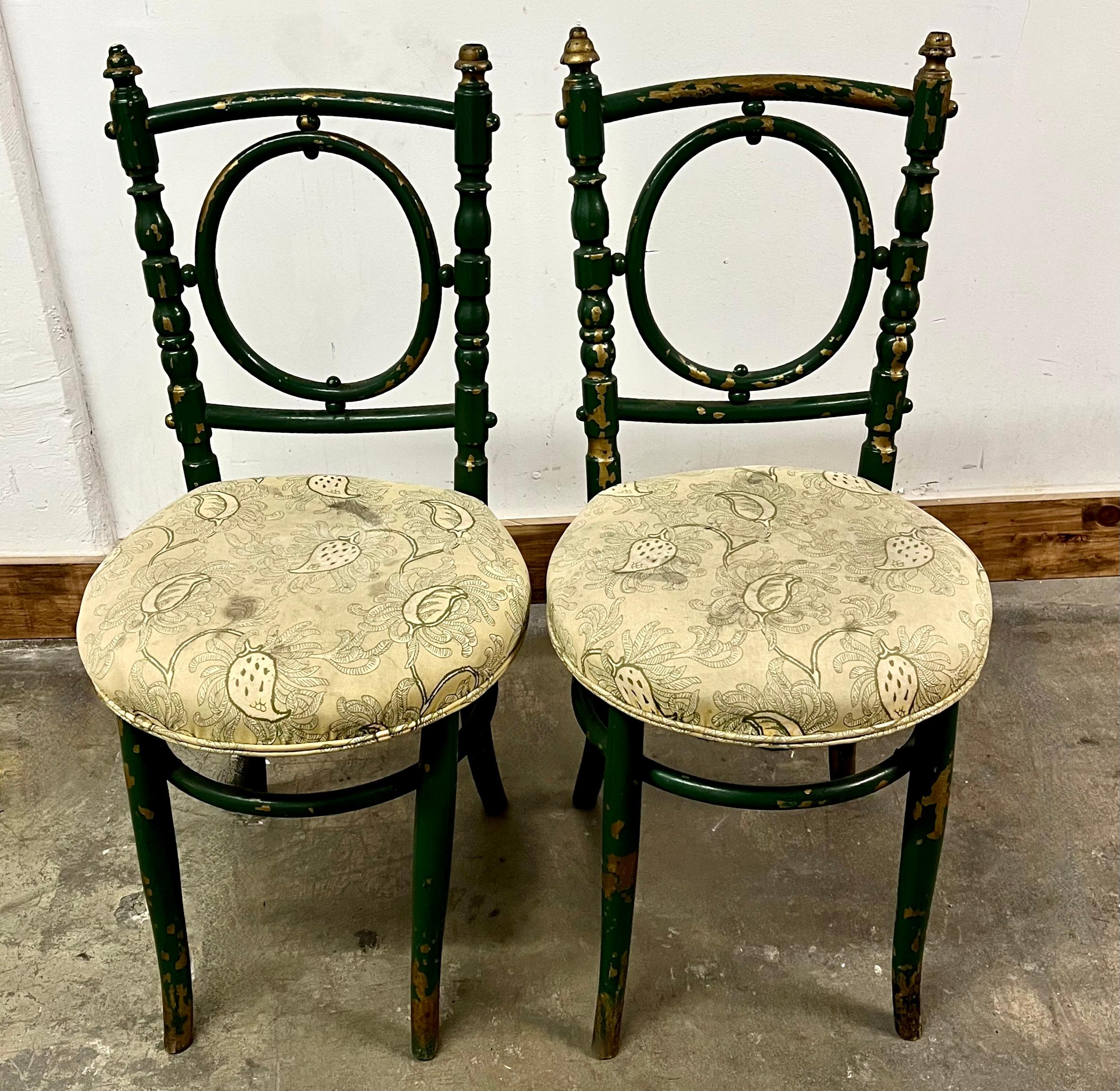 Pair of wonderfully designed wooden bentwood chairs with gilt details. The chairs are original. The design is unique and rare and would make a lovely decorative pair in many spaces. A compliment to any room.