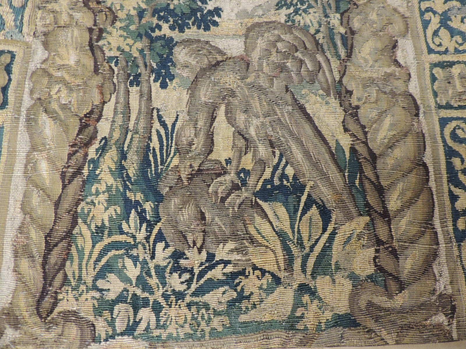 19th century green and gold verdure tapestry fragment, depicting an architectural arch with the forest in the background. A bird of pray in the center.
Framed with small french ribbon all around and backed with linen.
