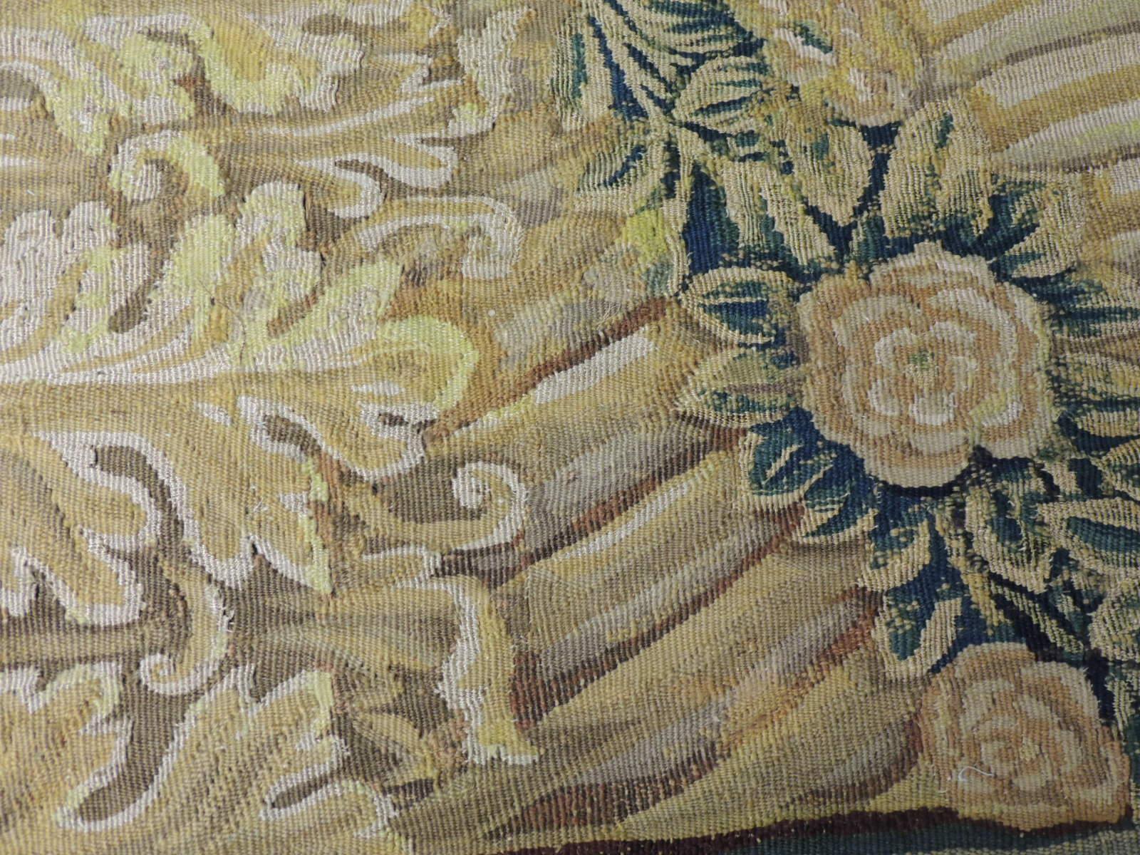 19th century green and gold verdure tapestry fragment, depicting acanthus leaves and flowers.
Framed with small French ribbon all around.
