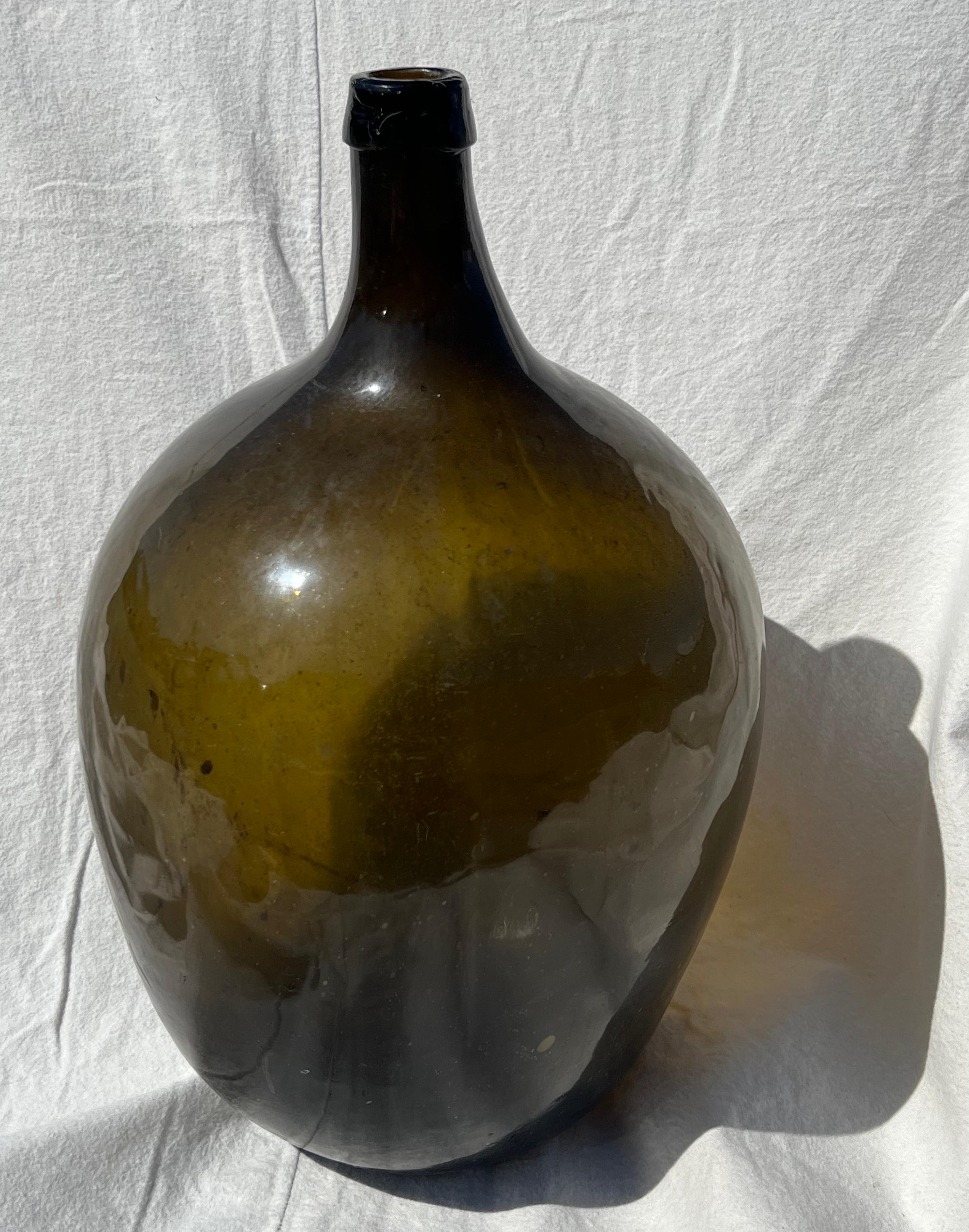 19th century green glass demijohn bottle in excellent condition.