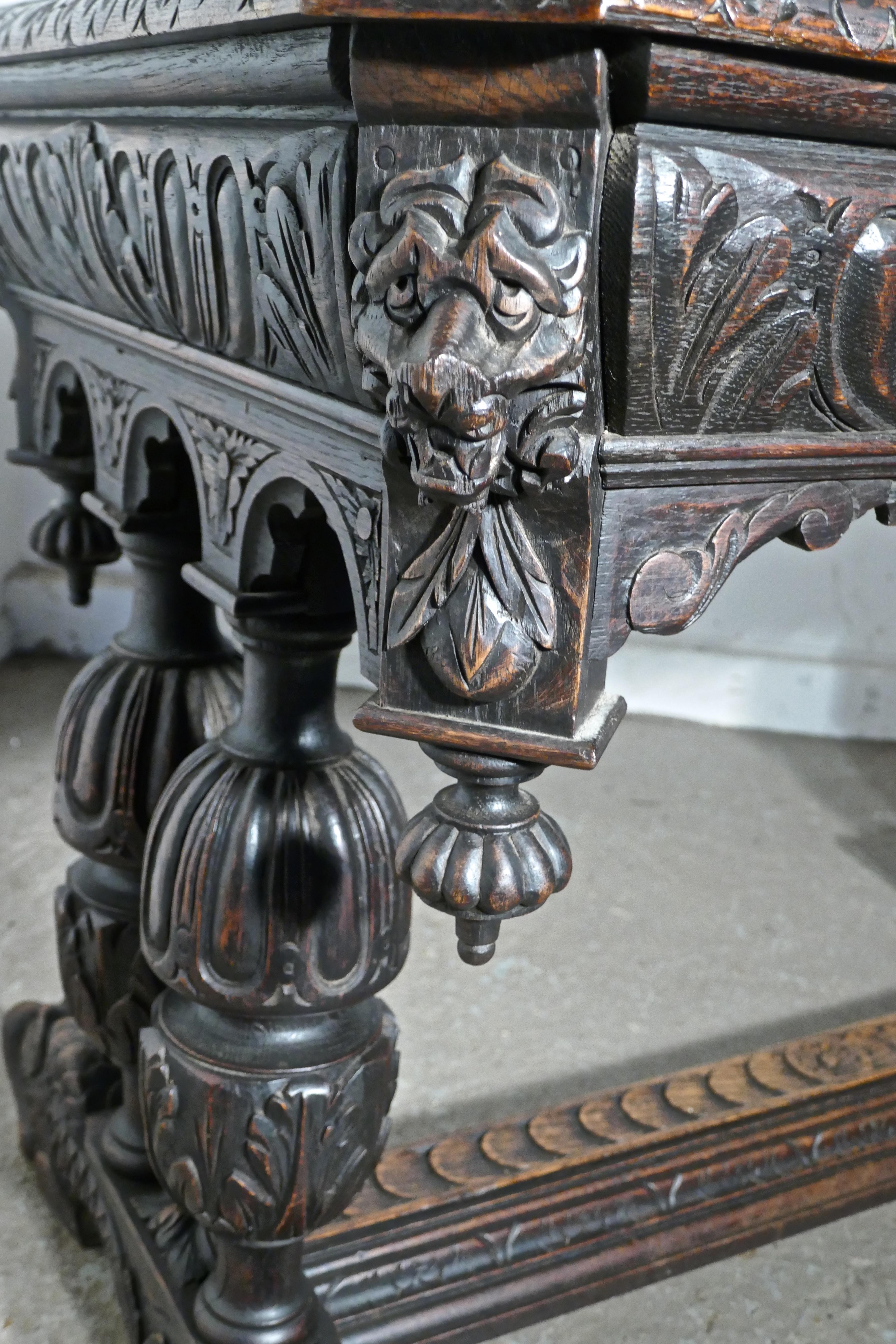 19th century green man carved oak hall or centre table
 
This is an intricately and very attractive piece, of Gothic carved oak furniture. The carving is Fine and very detailed and the oak has an good patina

There is a long drawer along one