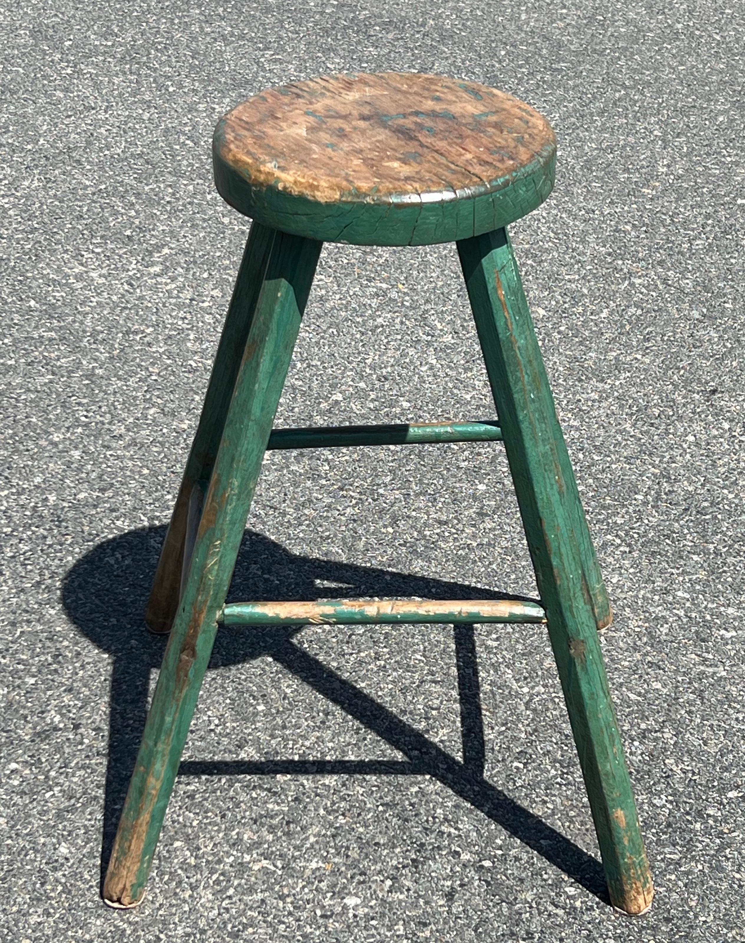 19th century stool with thick 11 inch oval seat, widely splayed legs, in original green paint.