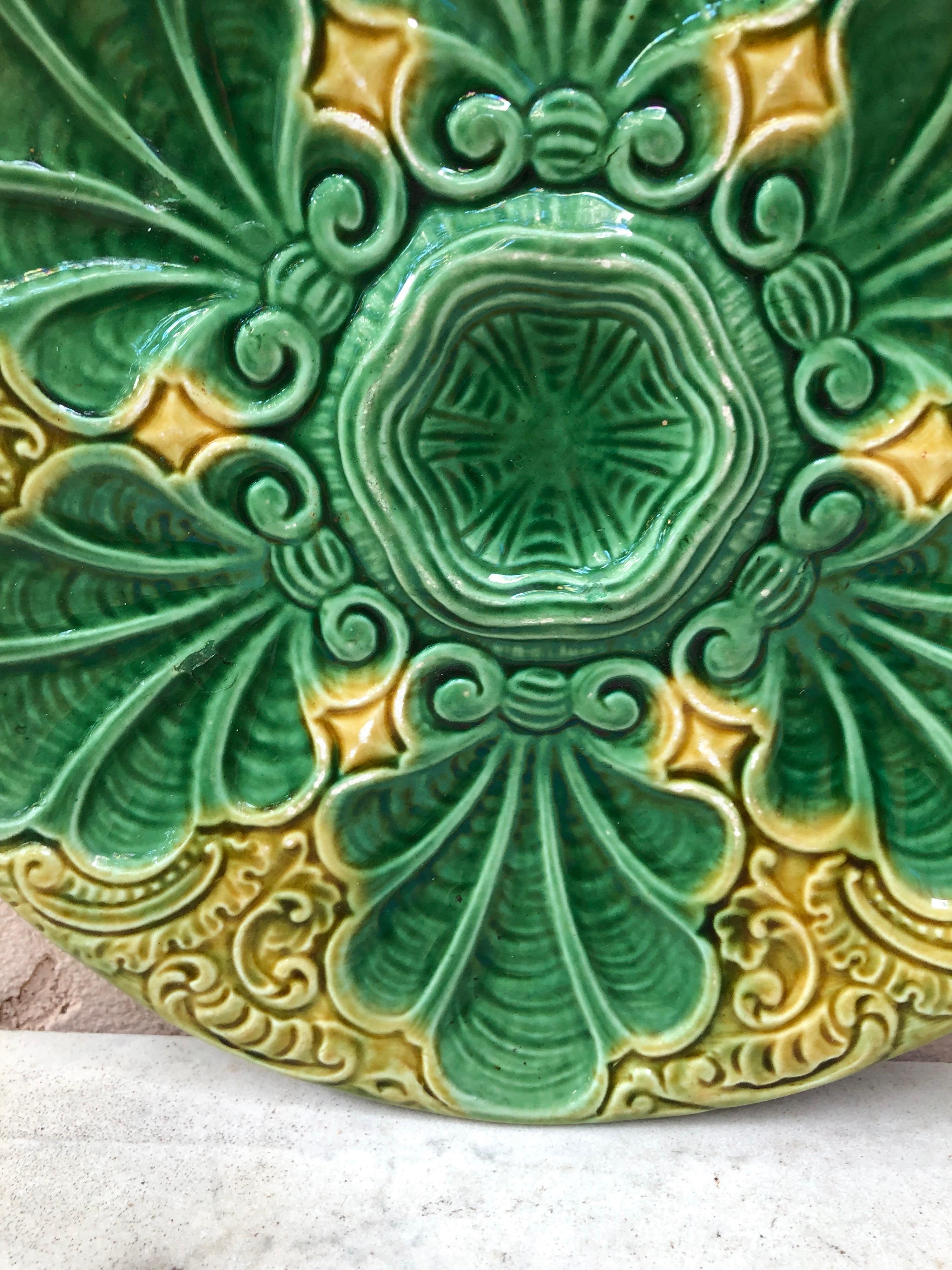 Colorful French Majolica green and yellow oyster plate with stylized leaves, circa 1890.
