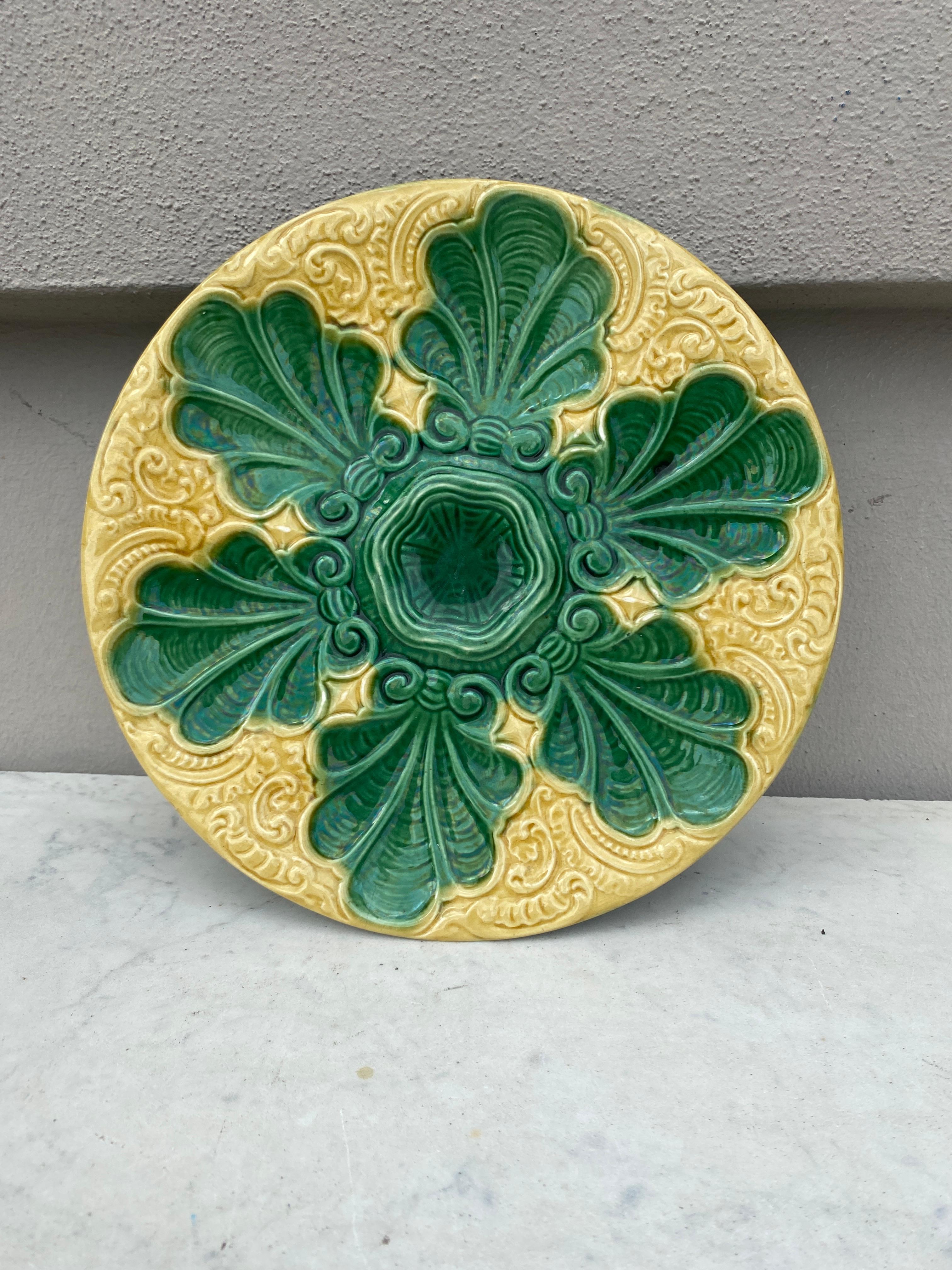 Colorful French Majolica green and yellow oyster plate with stylized leaves, circa 1890.