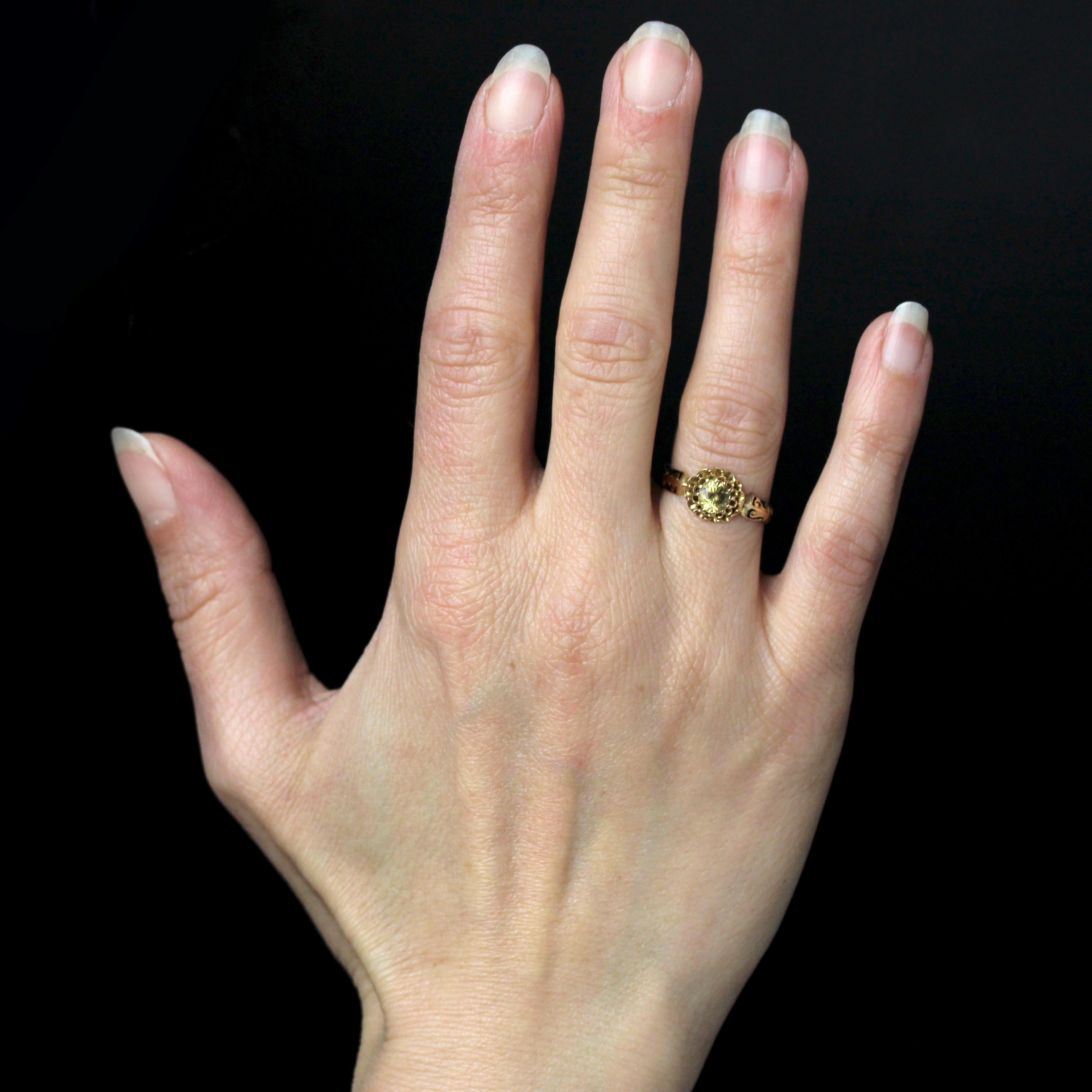 Bague en or rose 18 carats, poinçon hibou.
Cette bague-fleur féminine présente un anneau d'or décoré à la base et sur les deux côtés de motifs d'arabesques, partiellement émaillés de noir. Il contient une monture dahlia avec un saphir jaune/vert au
