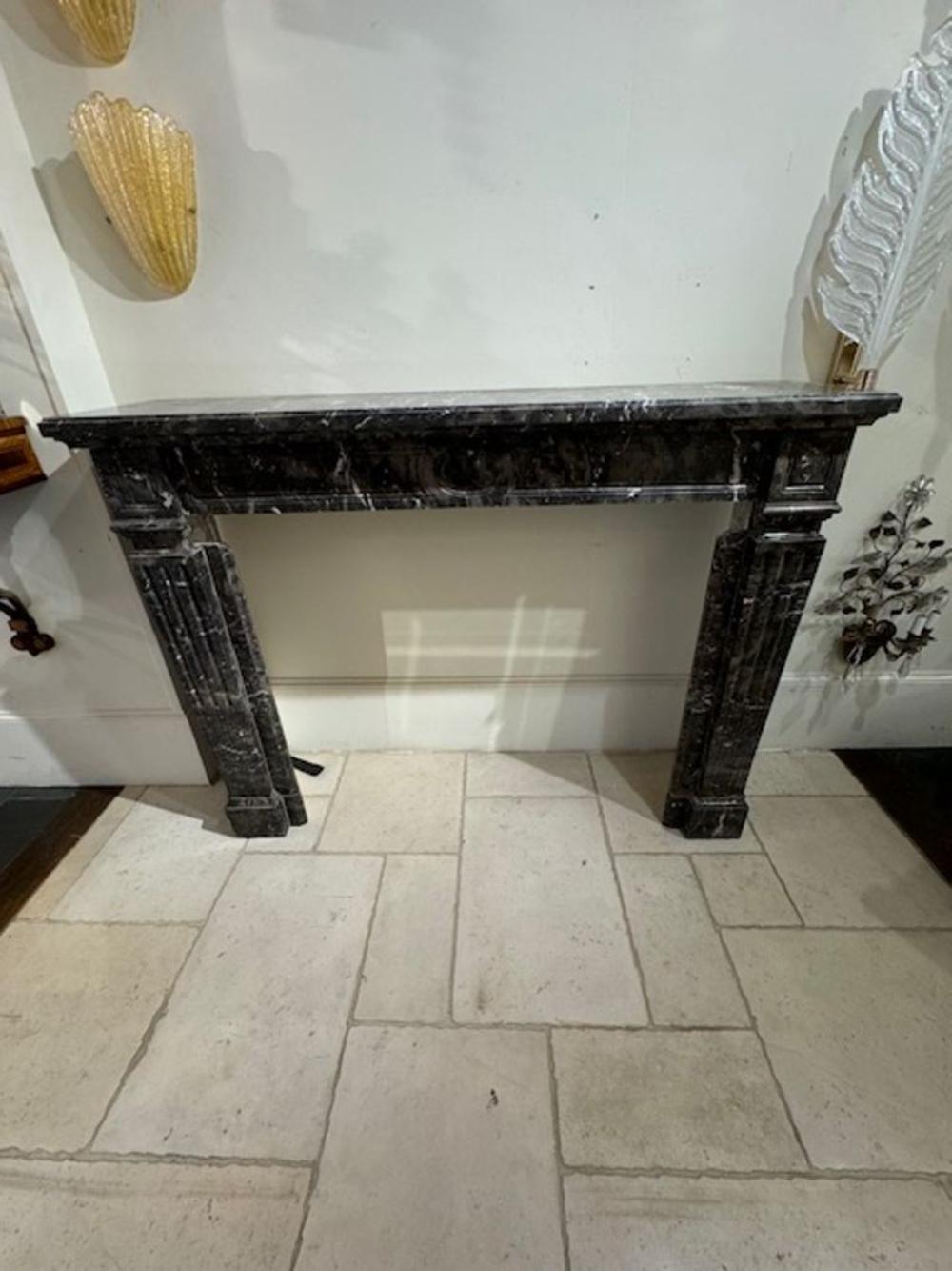 Handsome 19th century French Louis XVI grey marble mantel. Adds a real touch of elegance! Circa 1880
57w x 15d x 43.5h