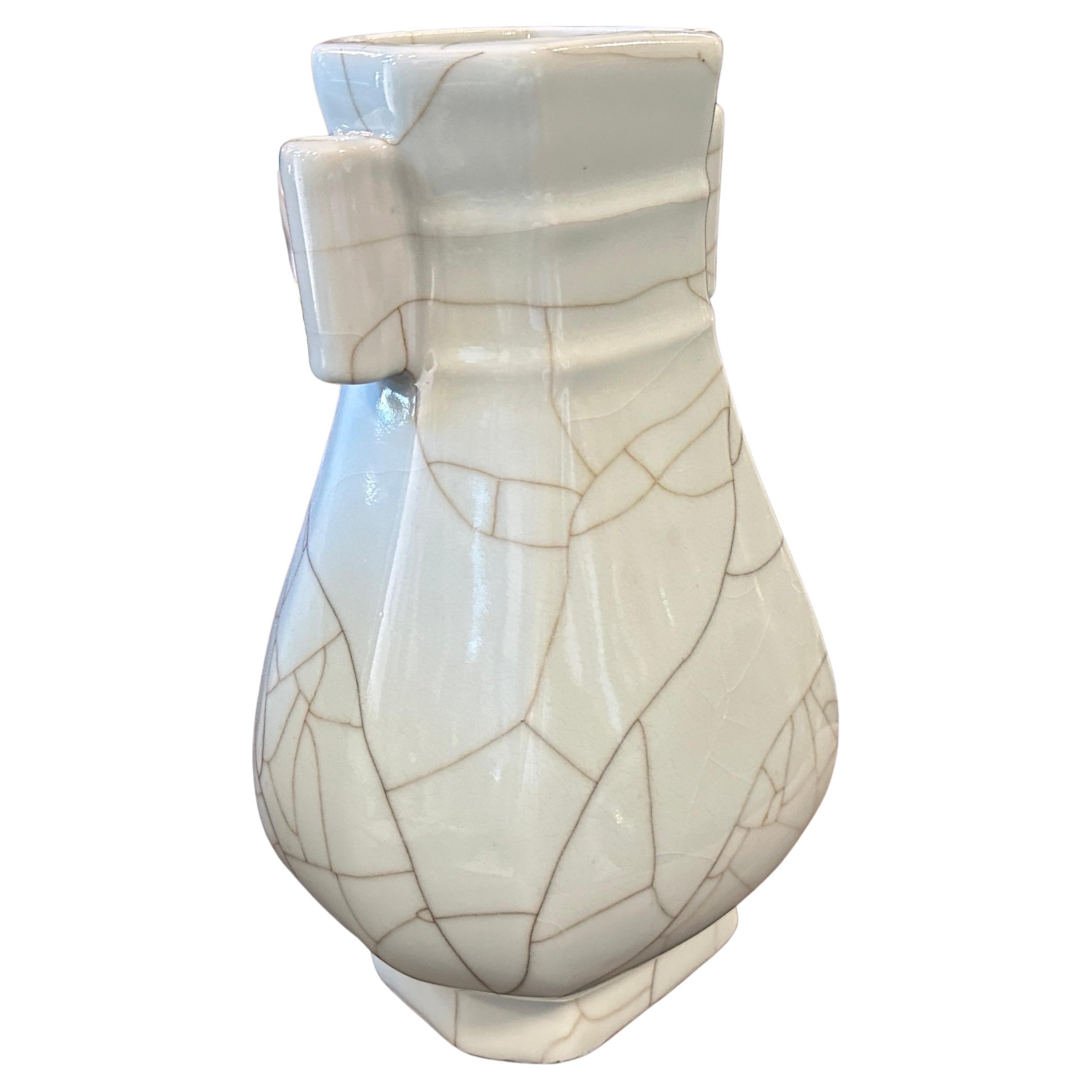 A simple and elegant well shaped Celadon vase manufactured in China in the late 19th century, the vase is covered overall with a crackled grey celadon glaze. The glaze it's smooth and even, with a slight sheen that catches the light, neck is flanked
