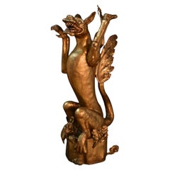 19th century griffin in gilded iron on a gothic wooden pedestal (Germany)