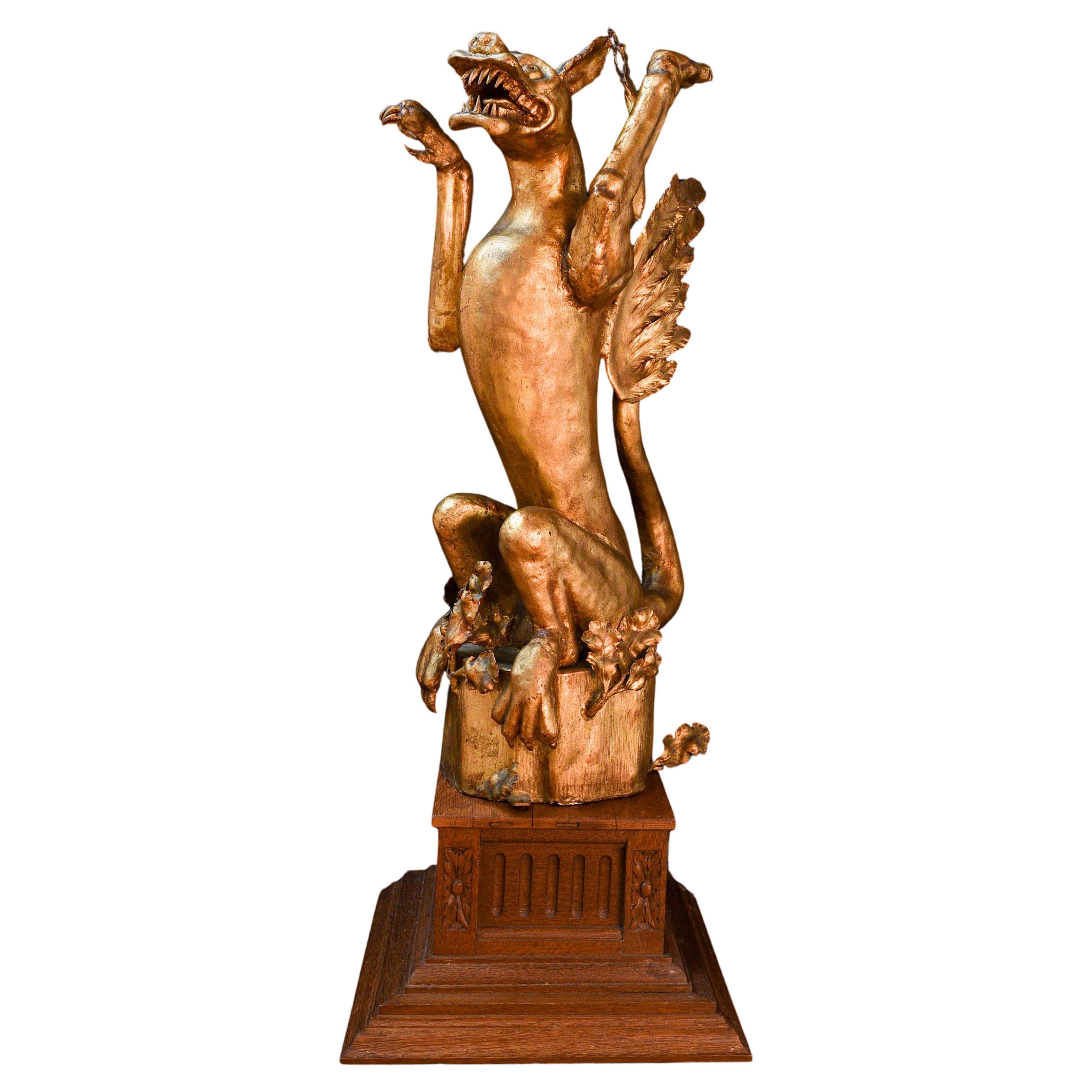 19th century griffin in gilded iron on a gothic wooden pedestal (Germany) For Sale