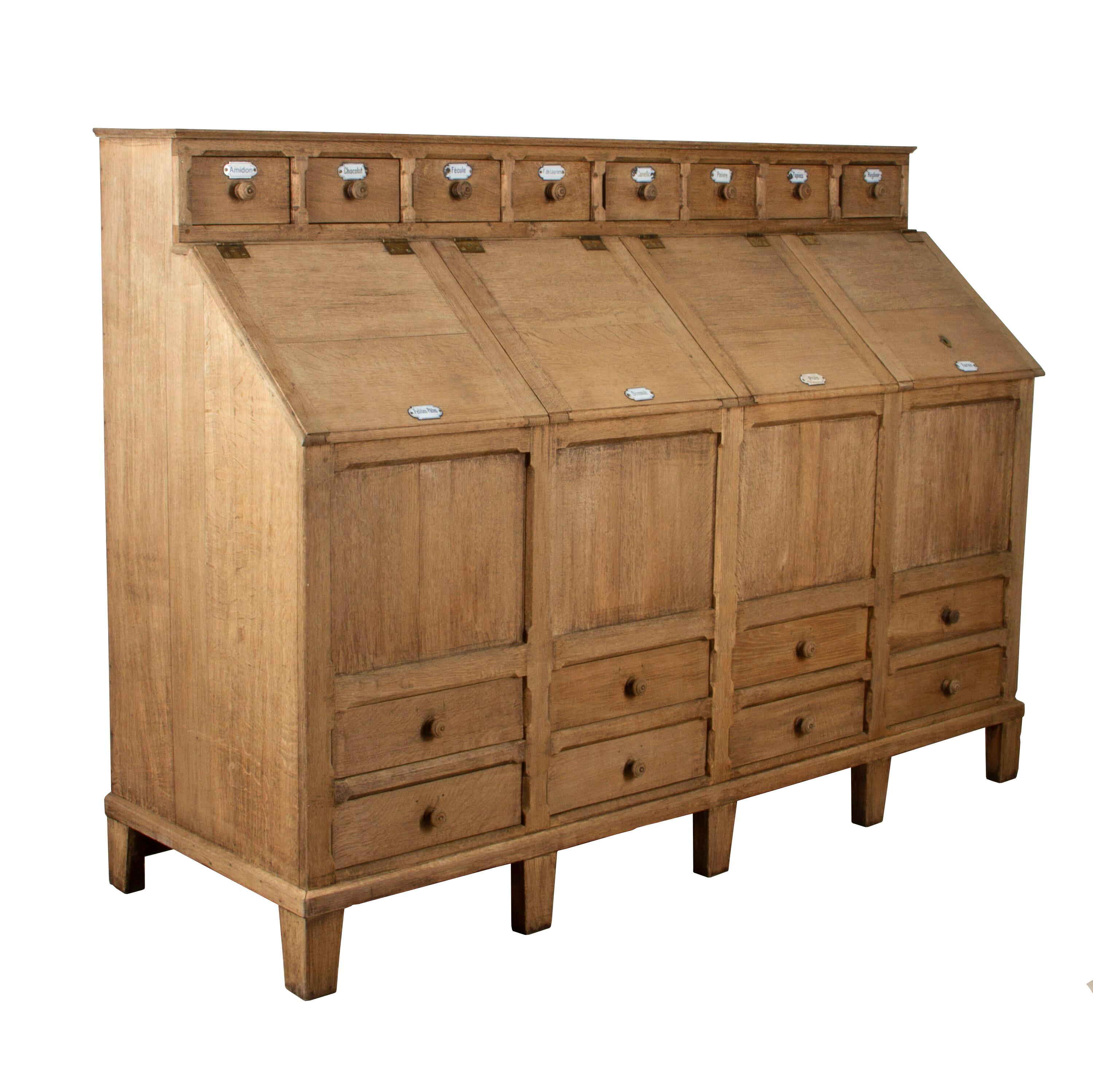 Impressive 19th century grocery counter. 
This wonderful counter has eight drawers with its original enameled labels. 
Along the top of this counter, there are eight small drawers that open to a deep interior. Below, are four further drawers that