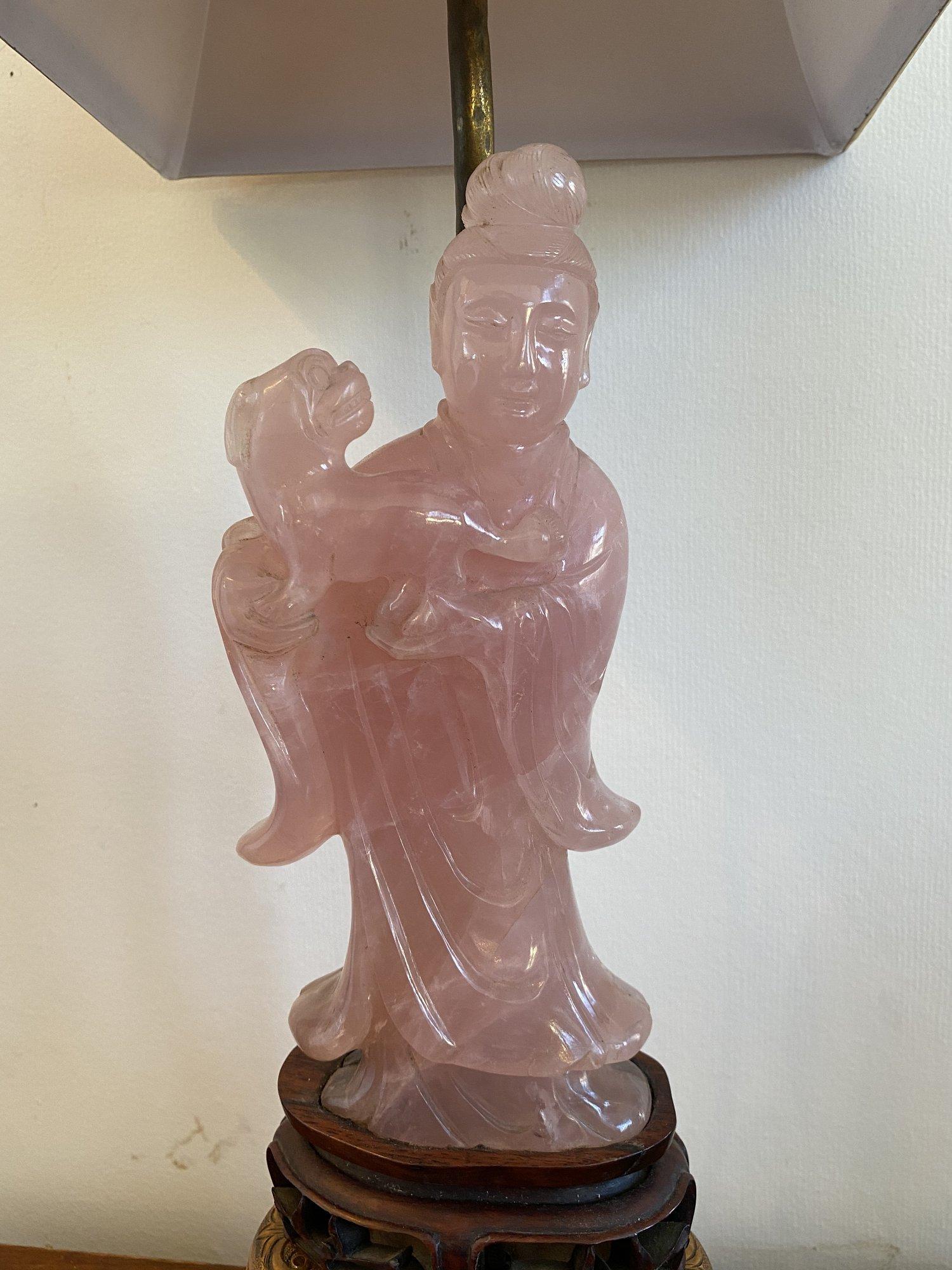 19th century Chinese carved rose quartz figure mounted as a lamp, depicting Guanyin holding a foo dog; mounted on a carved openwork wooden base, then mounted on a repousse metal base. Silk shade and large rose quartz finial. Dimensions of figure: