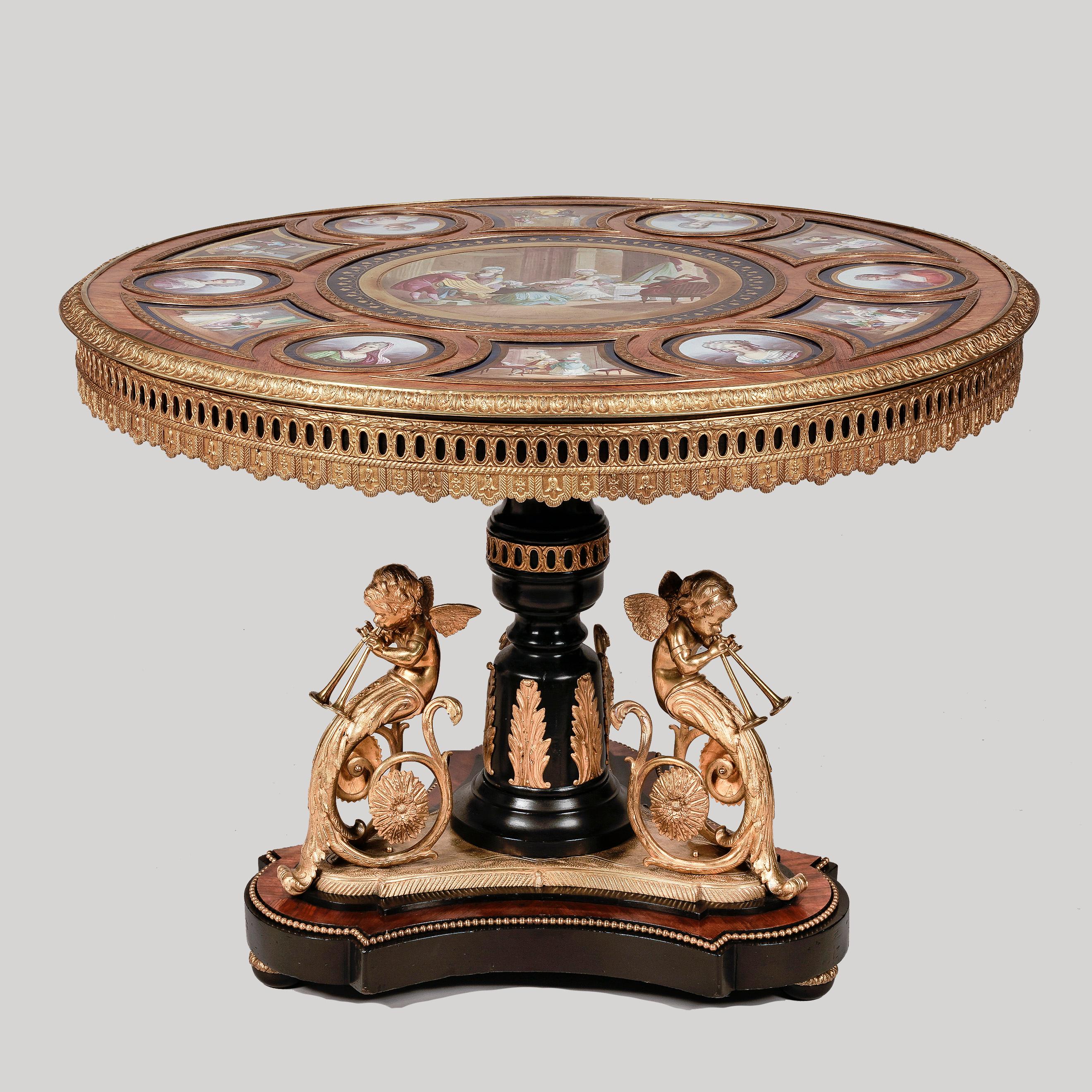 A superb gueridon centre table.
with sèvres style porcelain panels.

Constructed from bois noirci and kingwood with mercury fire gilded ornament, the central support rising from a tripartite plinth base on oblate bun feet and surmounted with