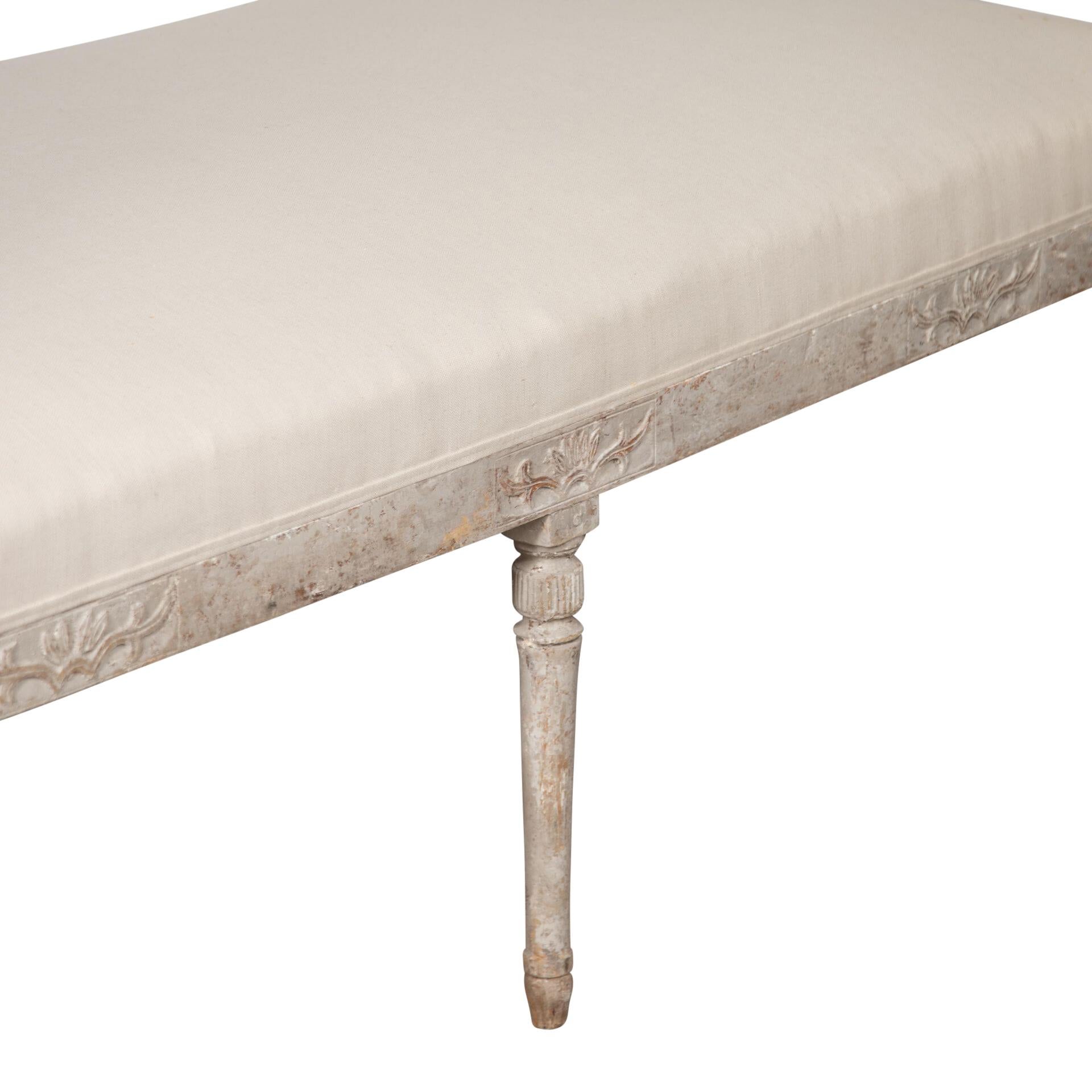 19th Century Gustavian repainted bench made in the region of Lindome, original size and newly upholstered in linen. 
Some minor restoration over the years.