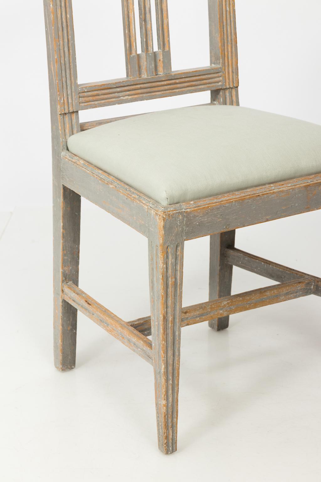 Antique Gustavian side chair with a painted frame, distress finish, and open square back design with center slats. Seat is upholstered in Victorian Hegan fabric, circa 1800s.
 