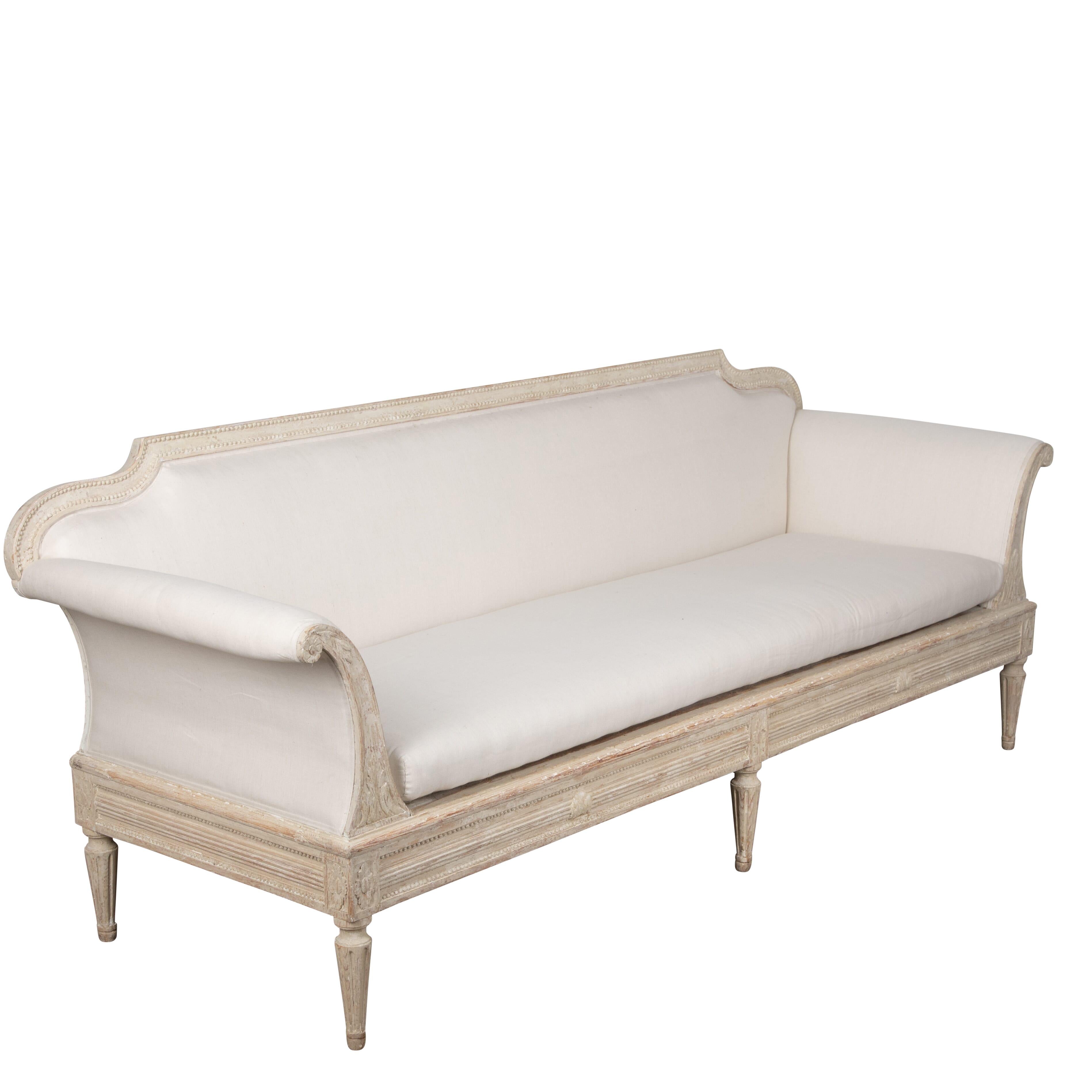 19th Century Gustavian sofa in the Manor House style.
With carved decoration on the arms, legs and apron.
This sofa has a detachable back so could also be used as a daybed.