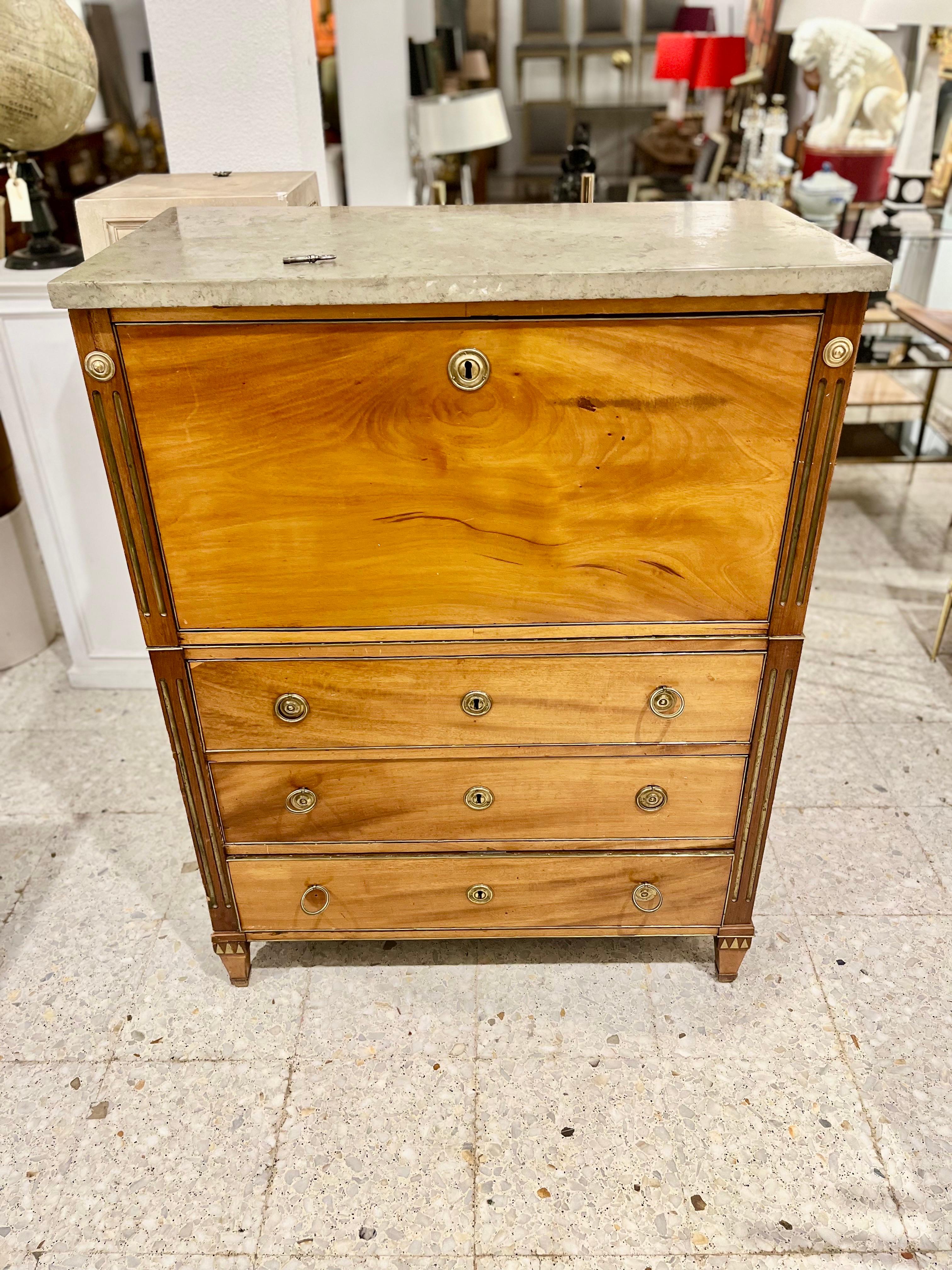 A Swedish writing desk, made of walnut wood, also decorated with gilded lateral grooves in the late Gustavian style. The writing desk is divided into two parts, each of which has bronze side handles to carry the upper part with a folding lid. Inside
