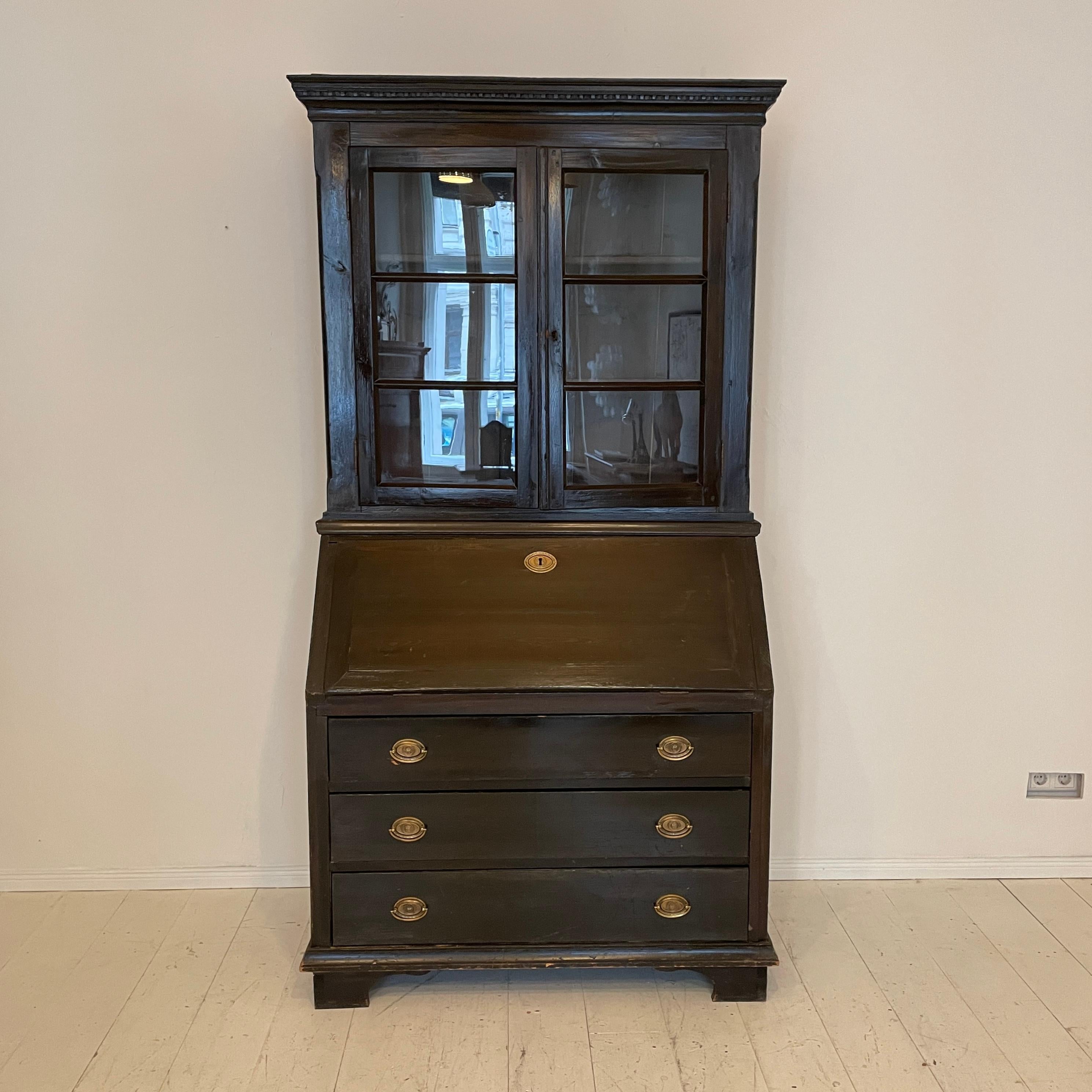 This beautiful 19th century Gustavian tall black writing desk secretaire was made in Sweden around 1820. It remains its original paint and is in a great antique condition.
It has got a Slant Front Desk and Glass Doors.
A unique piece which is a