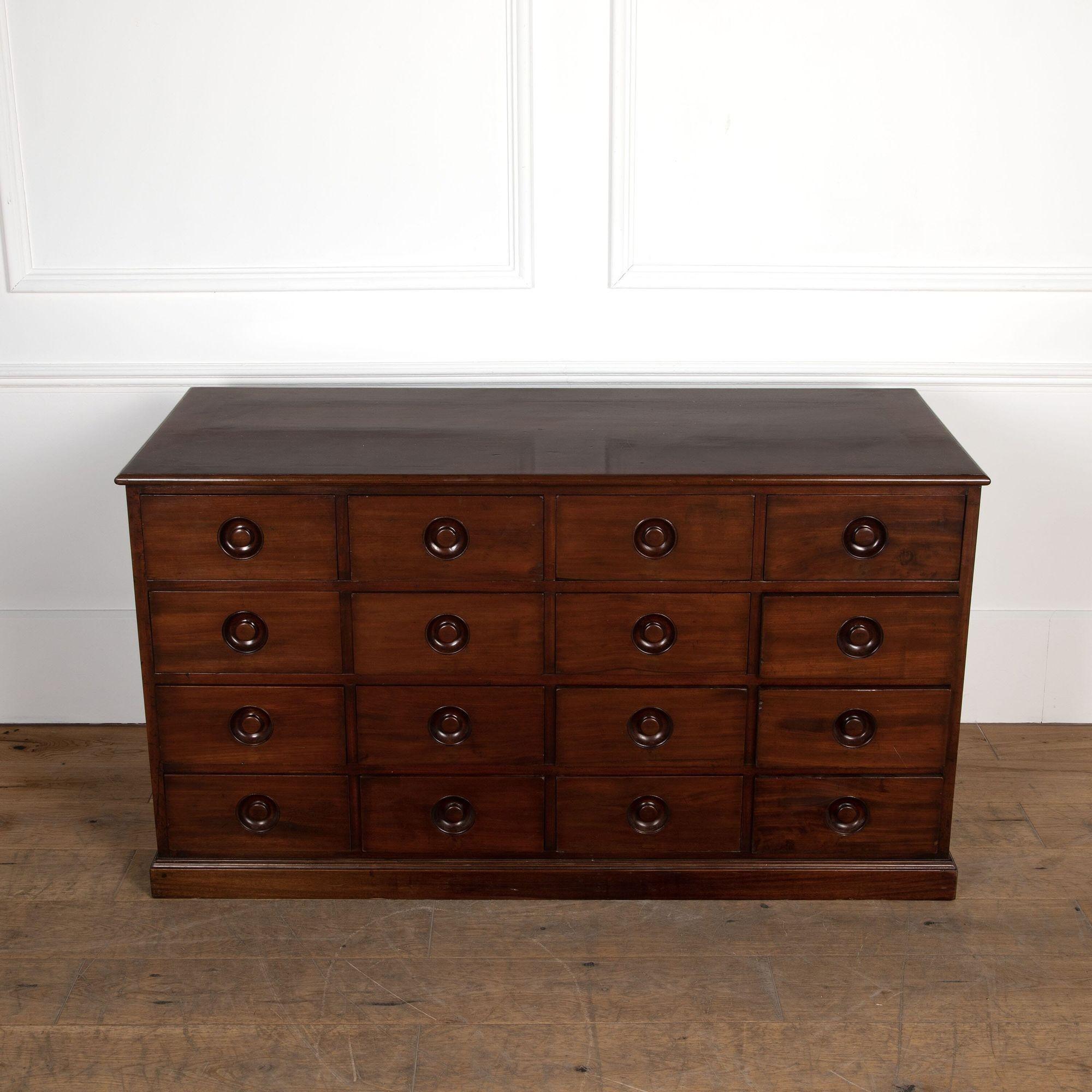 Early 19th century Cuban mahogany haberdasher's chest/counter. 
With sixteen drawers and paneled sides with some wear consistent with age to the top surface.
circa 1830.