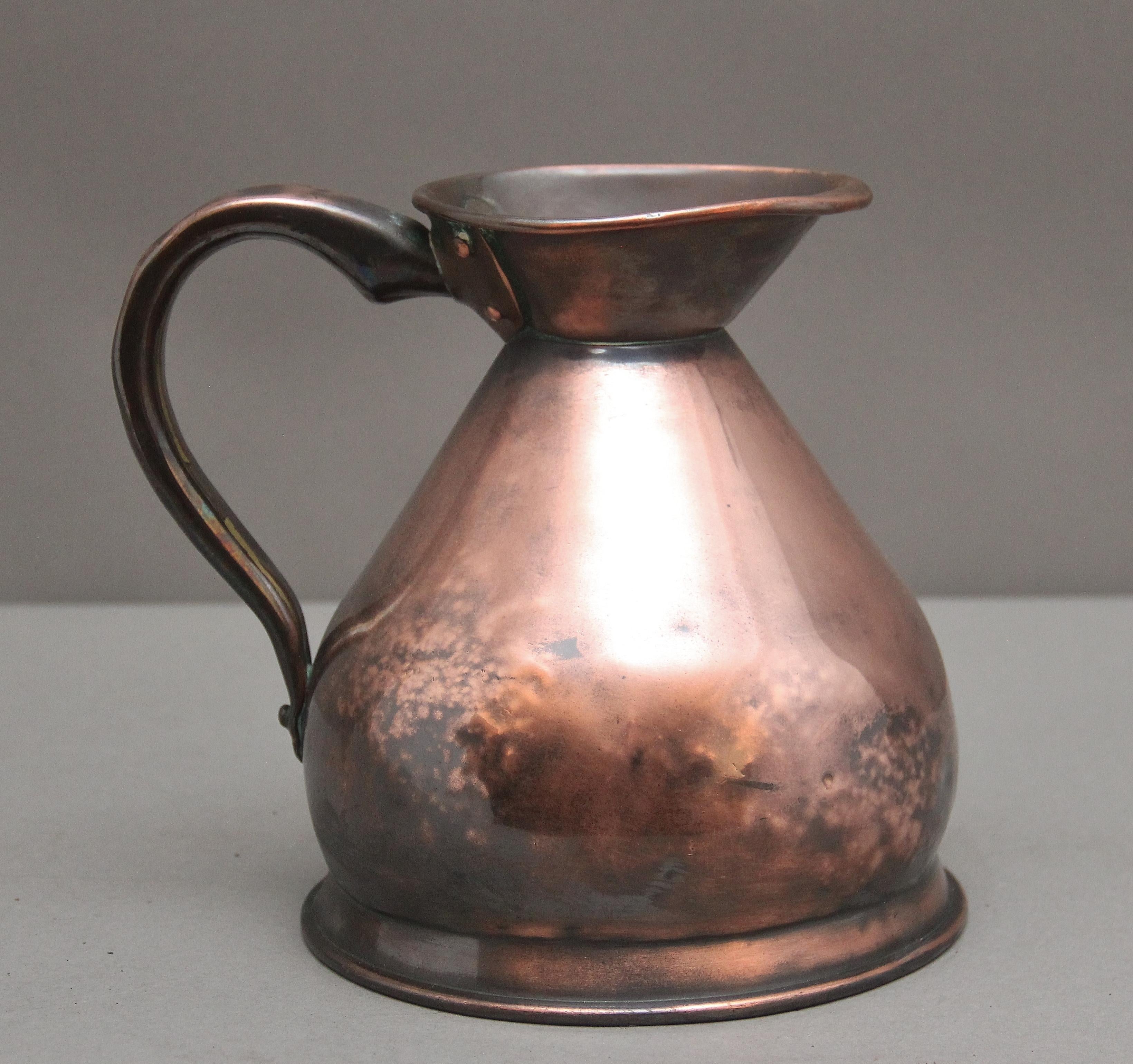 19th Century half gallon copper haystack measuring jug in very good condition and marked at the front with 1/2 gallon, having a large shaped handle to one side, the haystack jug named for it's wide based form and having a large spout.  Circa 1870.