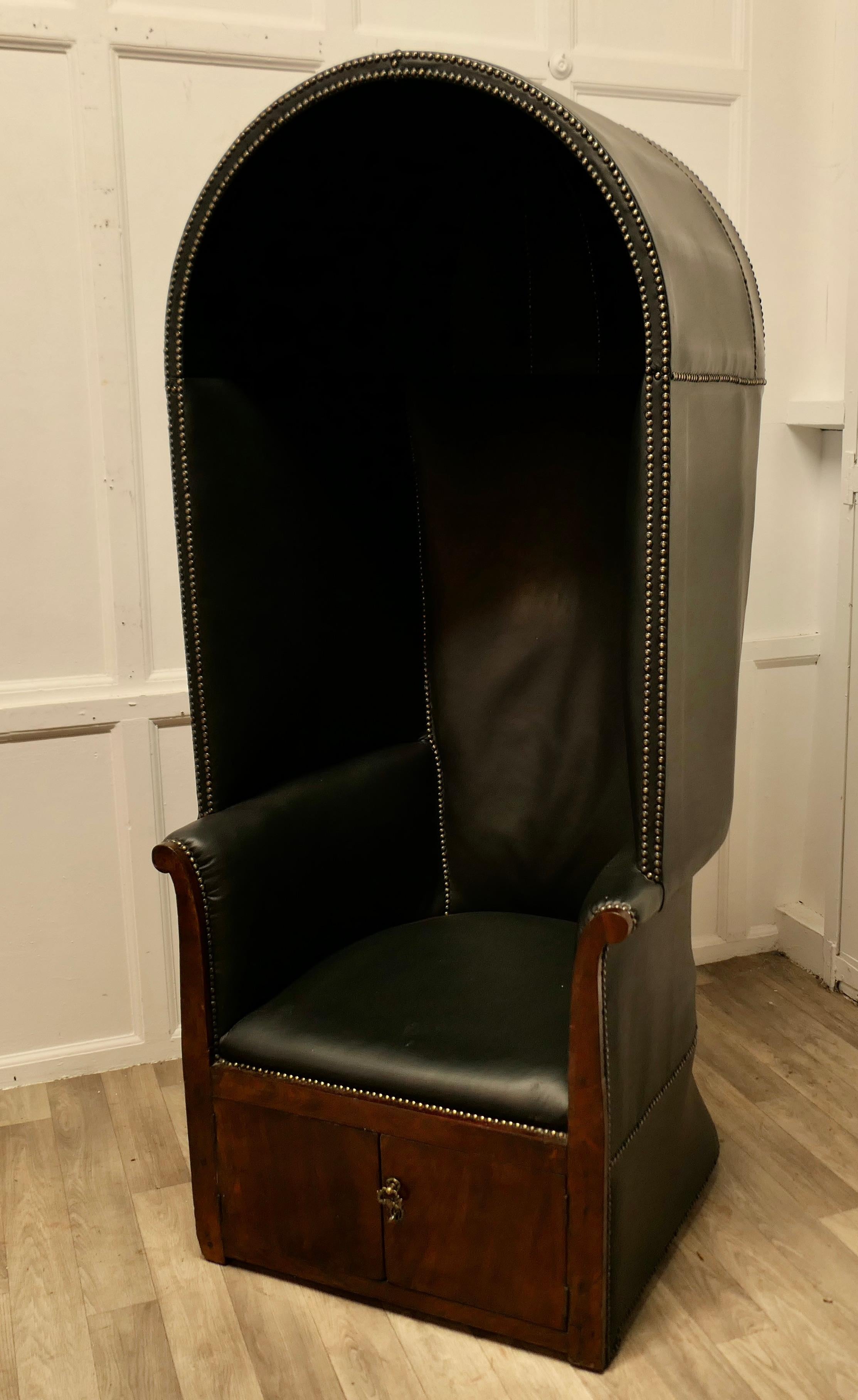 19th Century Hall Porters Chair 

The chair has been upholstered in Soft Black Leather with brass studs which are used very decoratively, under the seat there is a small 2 door cupboard 
This is a rare and early piece, the chair is 67” high and 29”