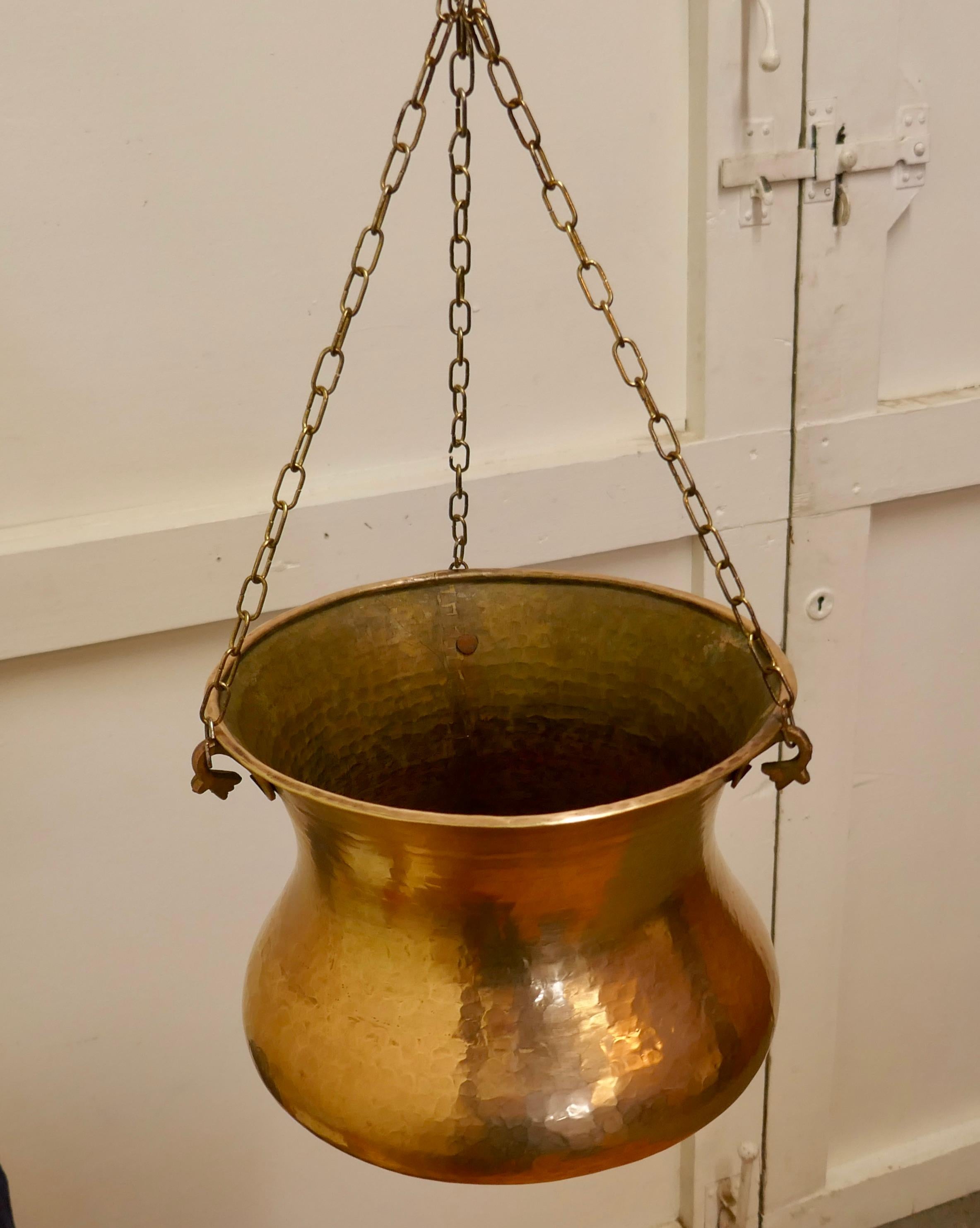 19th Century Hand Beaten Brass Cooking Pot, Cauldron 

This is a lovely early Cooking Pot, it is made in beaten brass, flaring out and rounded at the bottom 
The pot has a rolled top, and hangs on three chains
It is very sound with the usual