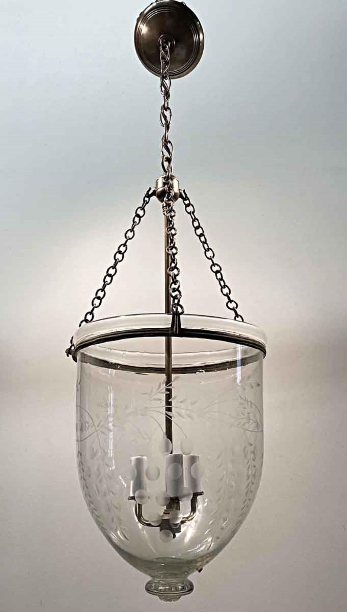 19th century English bell jar pendant lantern. It is a hand blown clear glass bell jar shade with etched vines, leaves and berries, plus a glass finial. The rolled ring around the neck is original to the piece. In the 1800s this bell jar held a