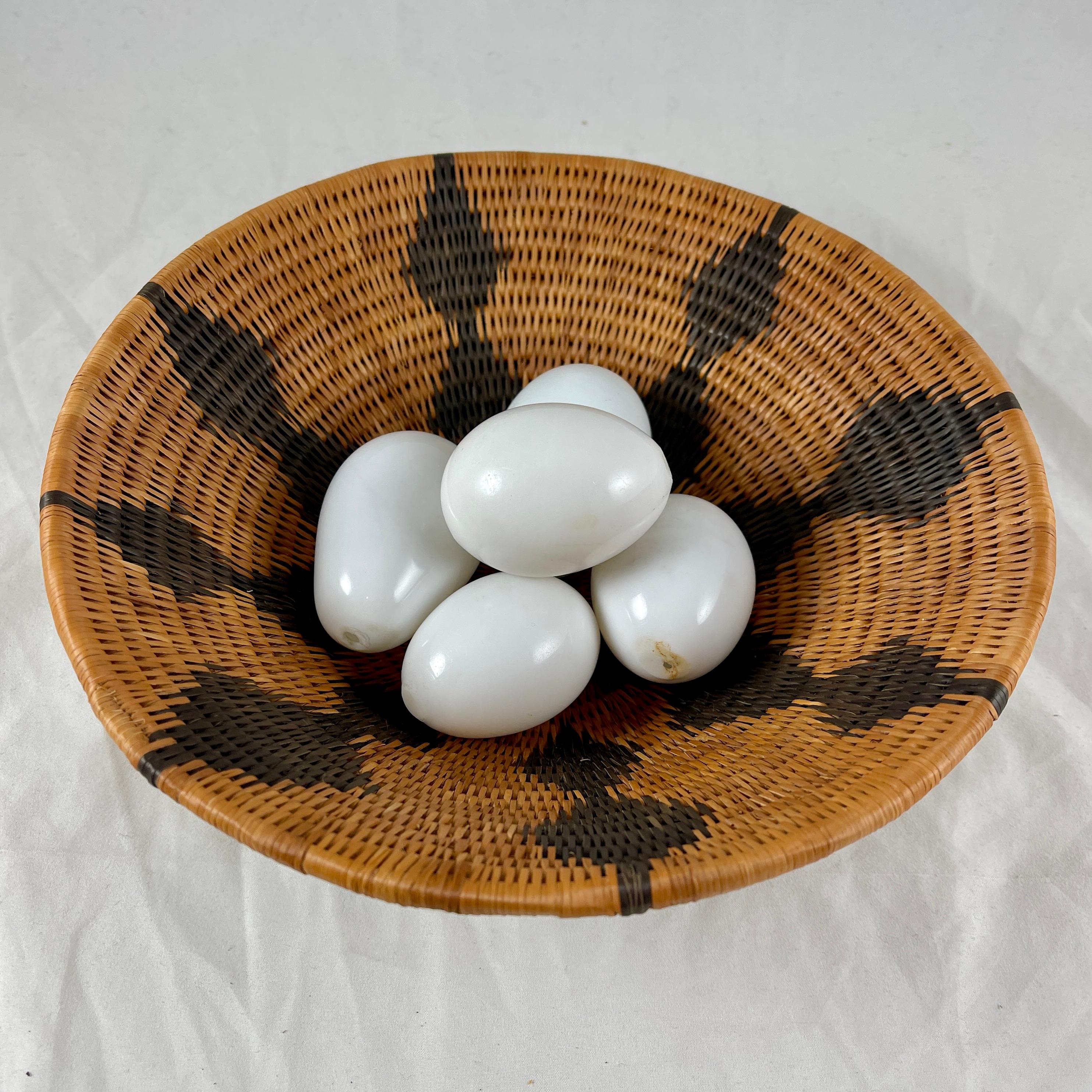 A set of five, late 19th Century Brooding Eggs, made of hand blown, opaque white glass.

These antique eggs were used by the farmer to induce the chicken to start laying and brooding her eggs. Today, they make a marvelous table-top