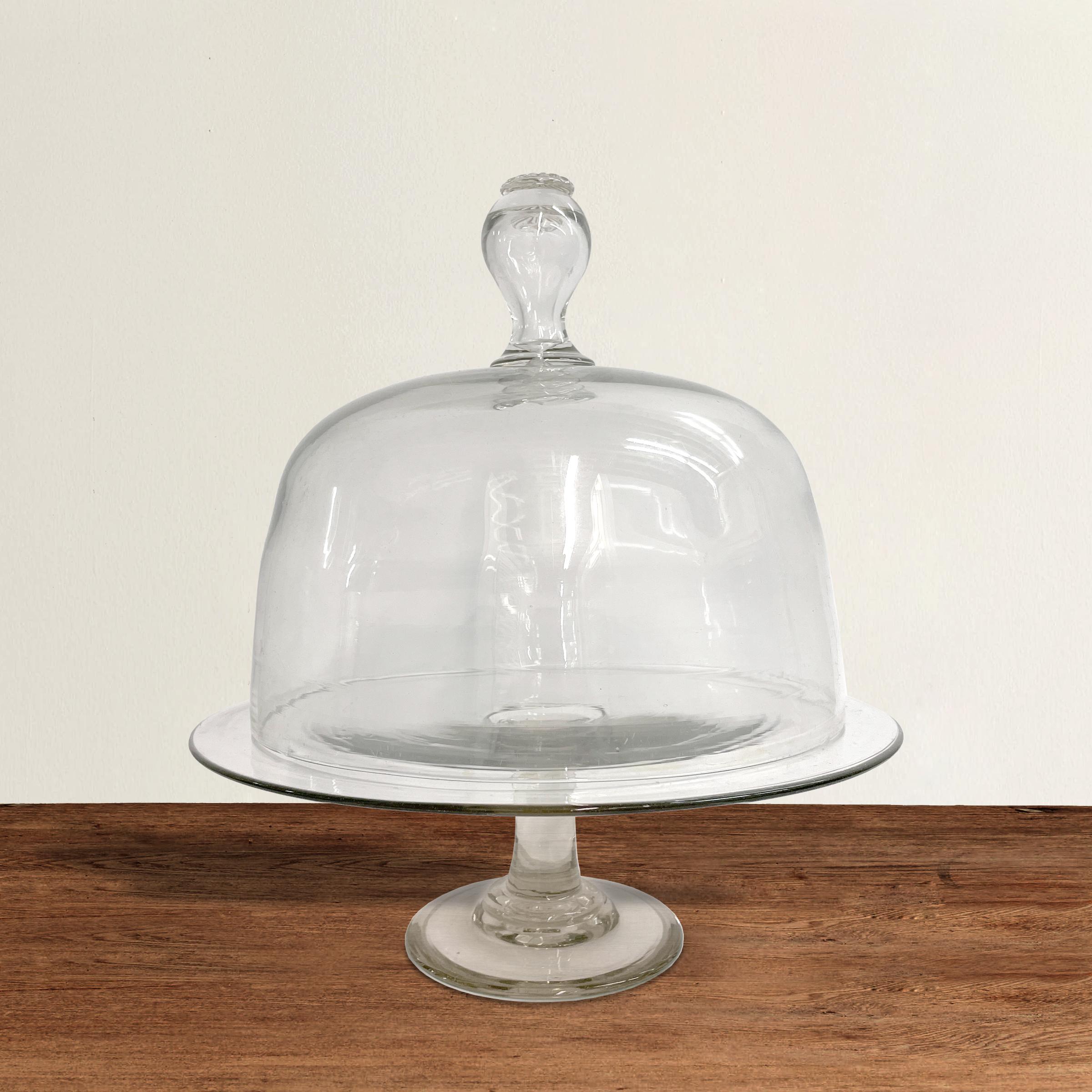 An incredible 19th century Belgian hand-blown glass food stand and dome with a wonderful knob with a captured bubble inside, and a crimped glass button on top. Perfect for showcasing your cake masterpieces, serving cheese, or protecting your