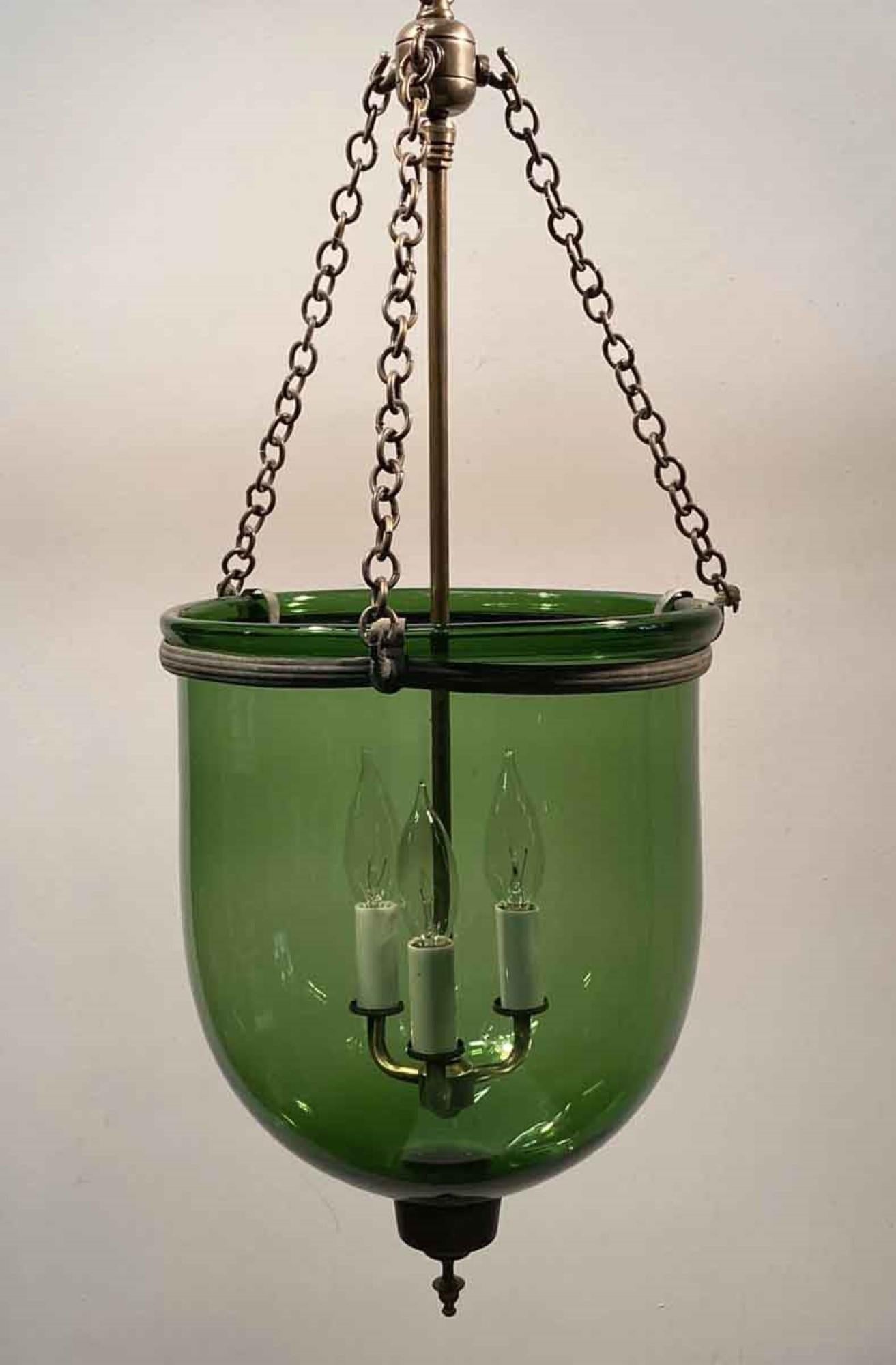 19th century hand blown green glass bell jar pendant lantern from England with a brass finial and new brass hardware. Features three candelabra lights. Price includes restoration. This can be seen at our 400 Gilligan St location in Scranton. PA.