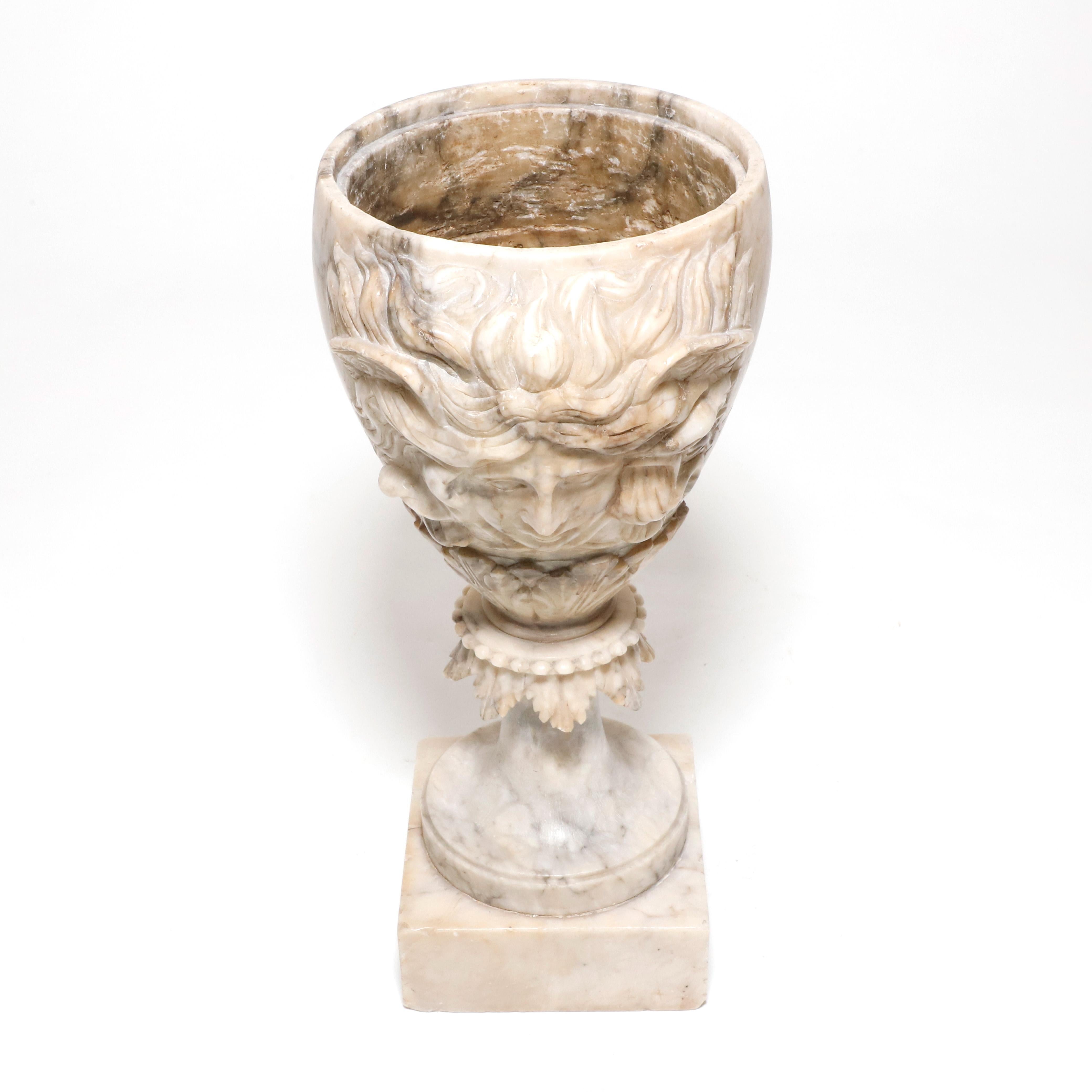 Grand Tour hand carved alabaster vase in goblet form with Dionysus head on one side. Elegant decorative and well crafter delicate piece, circa 1850s.

Property from esteemed interior designer Juan Montoya. Juan Montoya is one of the most acclaimed