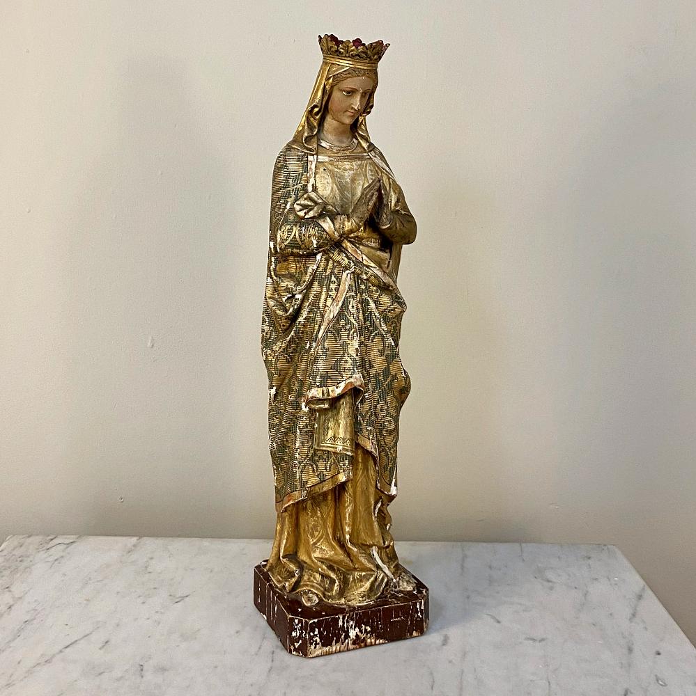 19th century hand carved and painted Madonna is an inspiring and uplifting sculpture that has been artfully carved and meticulously hand painted by a talented sculptor. The look on the Virgin Mary's face is one of serenity as she clasps her hands in