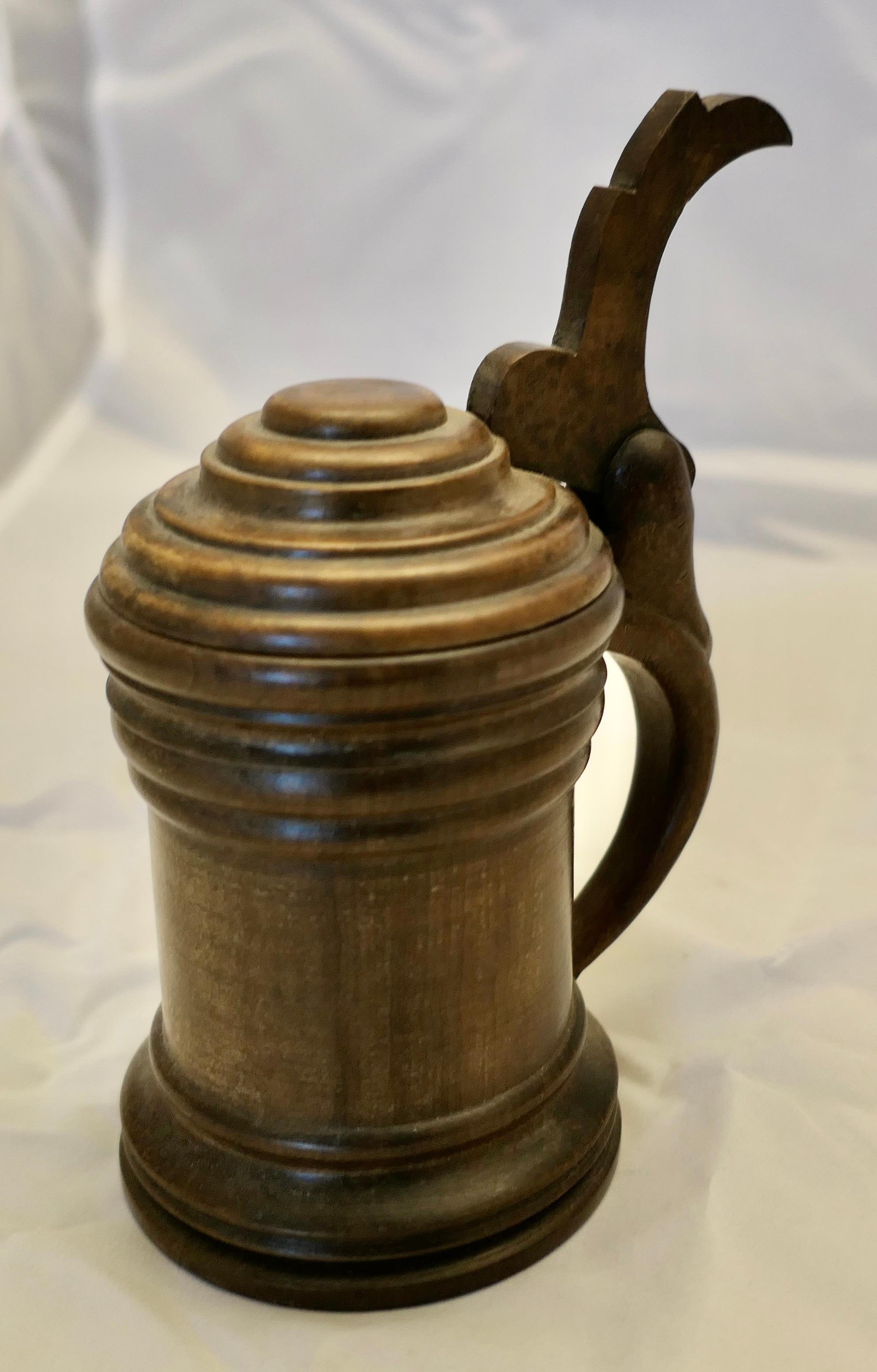 19th century Hand Carved Drinking Mug or Stein 

Beautifully turned with a pinned hinged lid, the mug has been turned from Yew wood, all in good condition holds about 1/2 pint, it is 8” tall 3.5” diameter at the bottom, 5.5” across
SC81