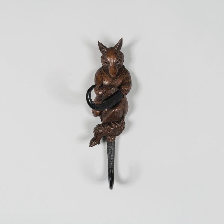 A Black Forest coat hook

Carved from solid Lindenwood, the cross-legged fox with glass-inset eyes brushing a horn, the second horn extending out from below his furry tail.
Brienz Area, circa 1890

Brienz, in the Bernese Oberland, Switzerland